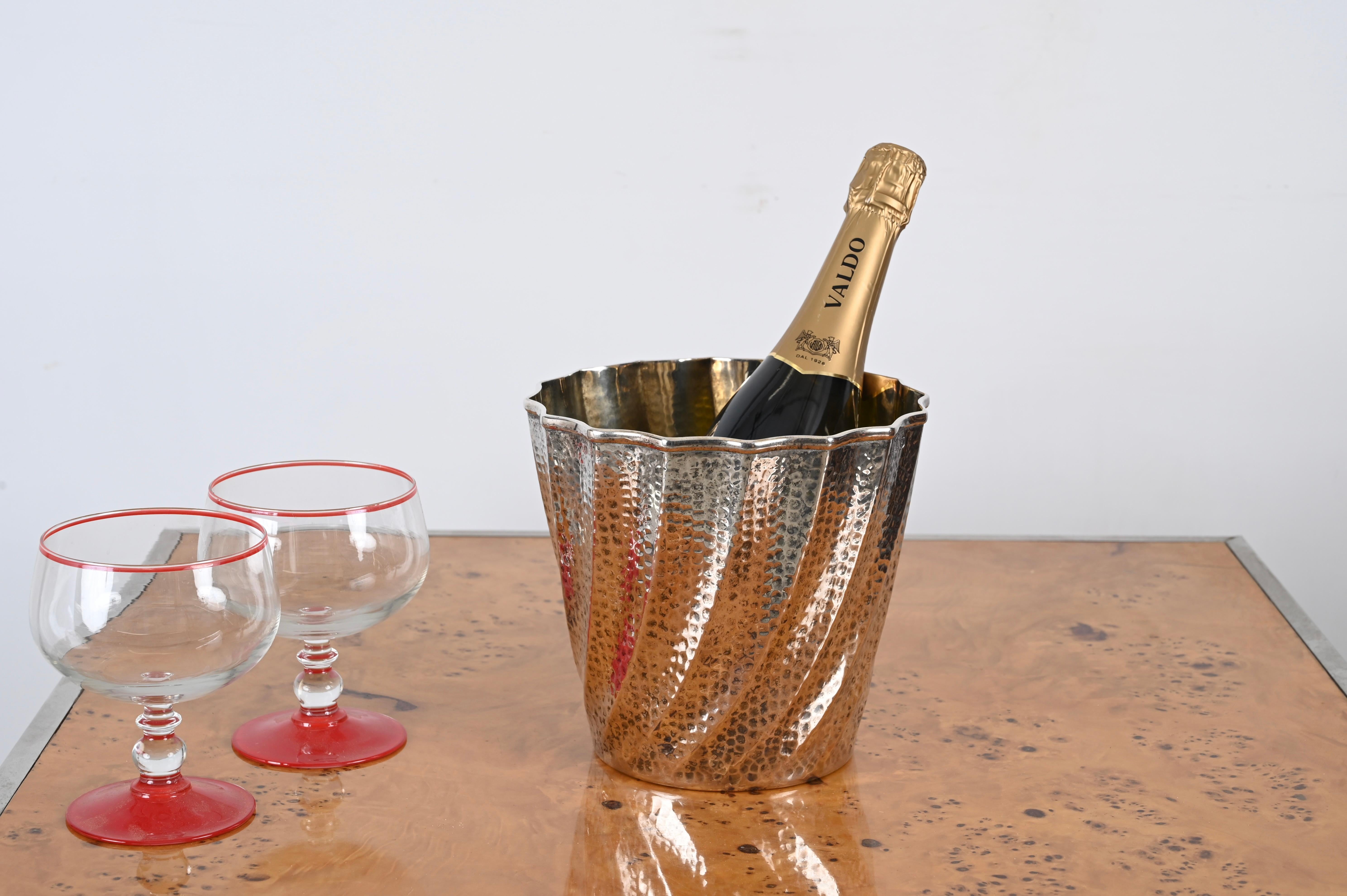 Gorgeous Mid-Century vermeil ice bucket in hammered metal which is silver-plated outside and goldplated inside. This fantastic piece was produced by Calegaro in Italy in the 1970s. 

This incredibly elegant ice bucket features a curved multifaceted