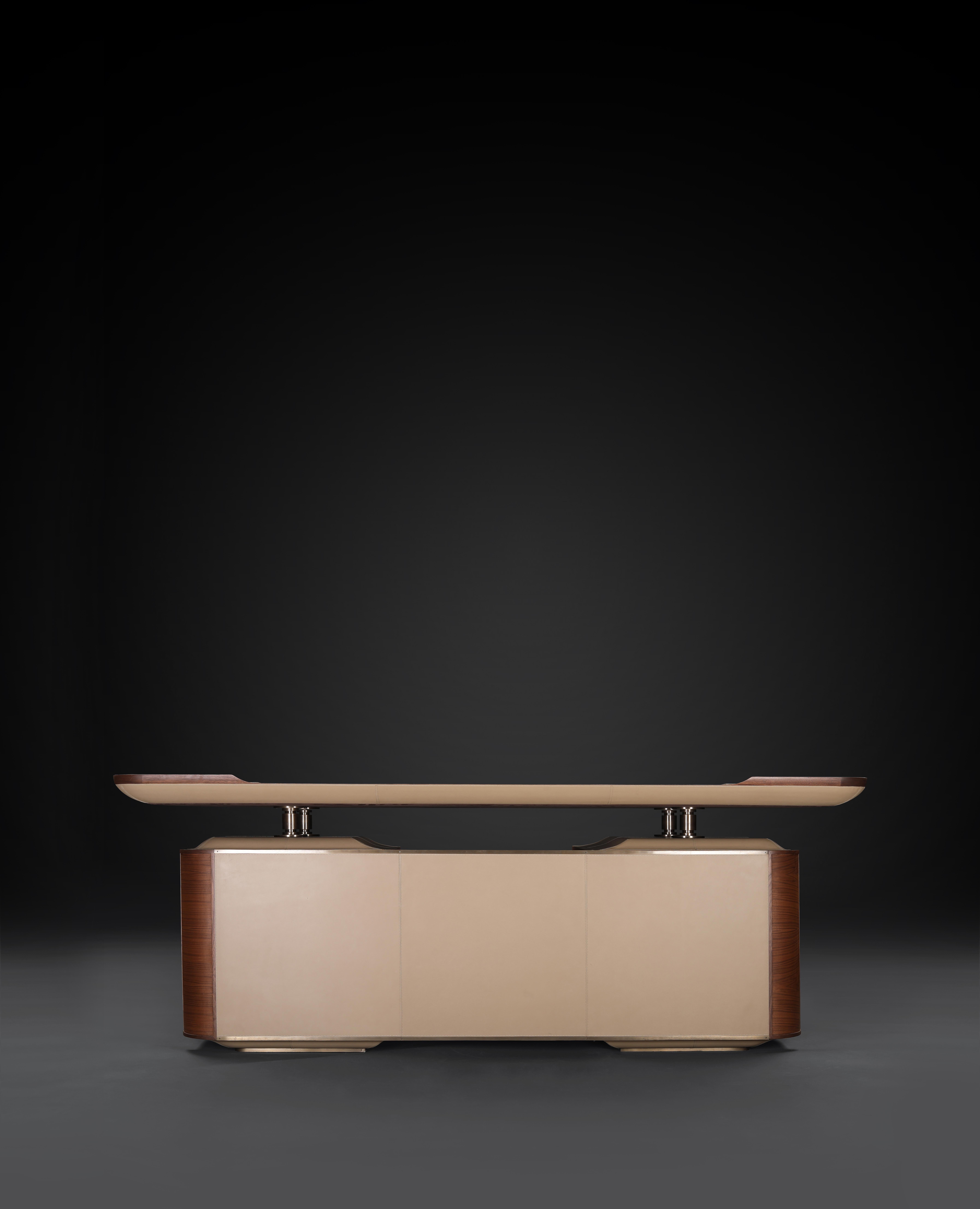 Calen desk by Madheke.
Dimensions: D 90 x W 210 x H 78.5 cm.
Materials: leather, wood, veneer, metal.

Classic leather front and upper, dead matte veneer, bronzed metal detailing.

Reflecting the finest in craftsmanship, innovation and