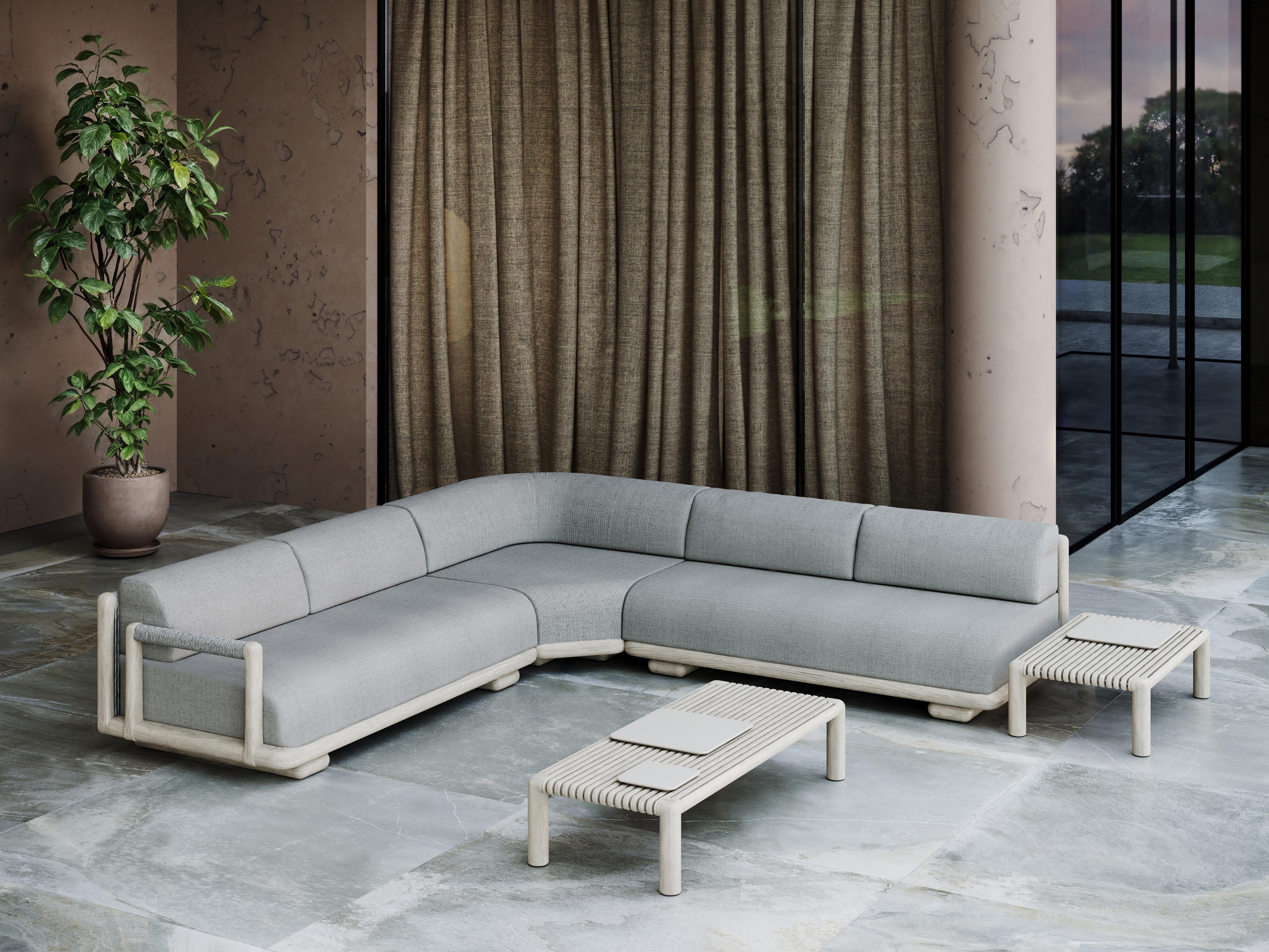 Caleo-Ash Teak Wood, Rope And Ethereal Fabric Corner Modular Sofa by SNOC
Dimensions: D 123 x W 123 x H 65 cm. SH: 42 cm.
Materials: Teak wood, rope, and Ethereal fabric. 

The Caleo Collection embodies understated luxury, blending contemporary form