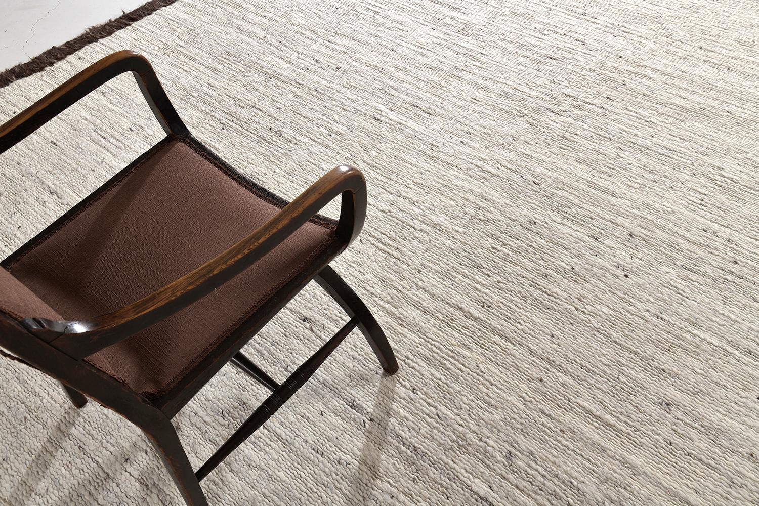 'Caleta' is a beautiful handwoven speckled ivory flat-weave, bordered with rich brown shag. A simple yet interesting design, 'Caleta' is a luxurious and timely design that will elevate any space. Mehraban's Sabbia collection is unique for its play