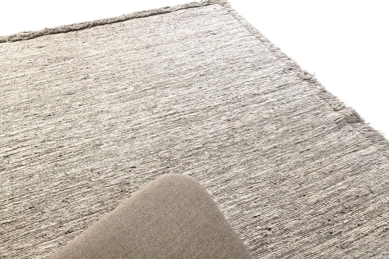 'Caleta' is a beautiful handwoven speckled natural grey flat-weave, bordered with a match shag exterior. A simple yet interesting design, 'Caleta' is a luxurious and timely design that will elevate any space. Mehraban's Sabbia collection is unique