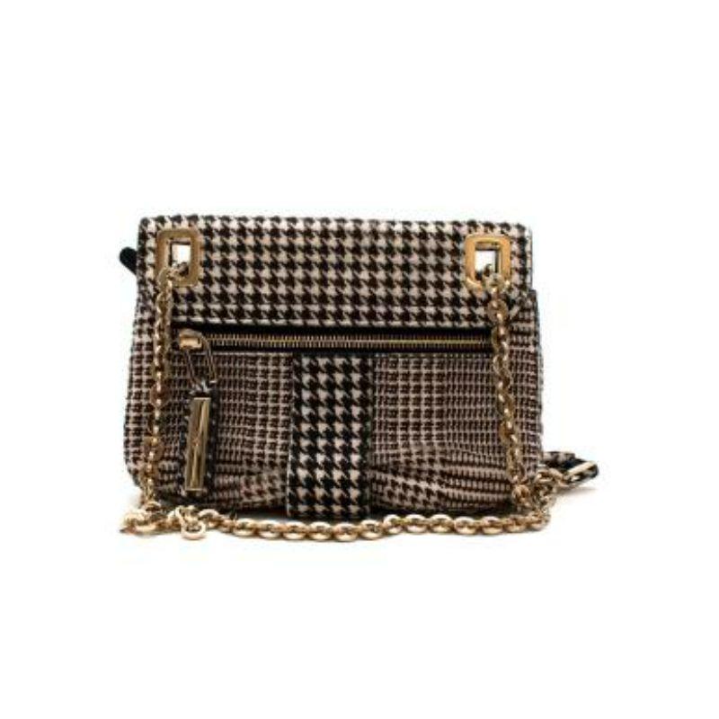 Roger Vivier Calf Hair Houndstooth Micro Metro Bag
 
 -Oversized top buckle clasp
 -Flap with magnetic closure and engraved with logo
 -Exterior back zip pocket
 -Single loop shoulder strap, gold-tone hardware accents
 -Middle zip compartment, and