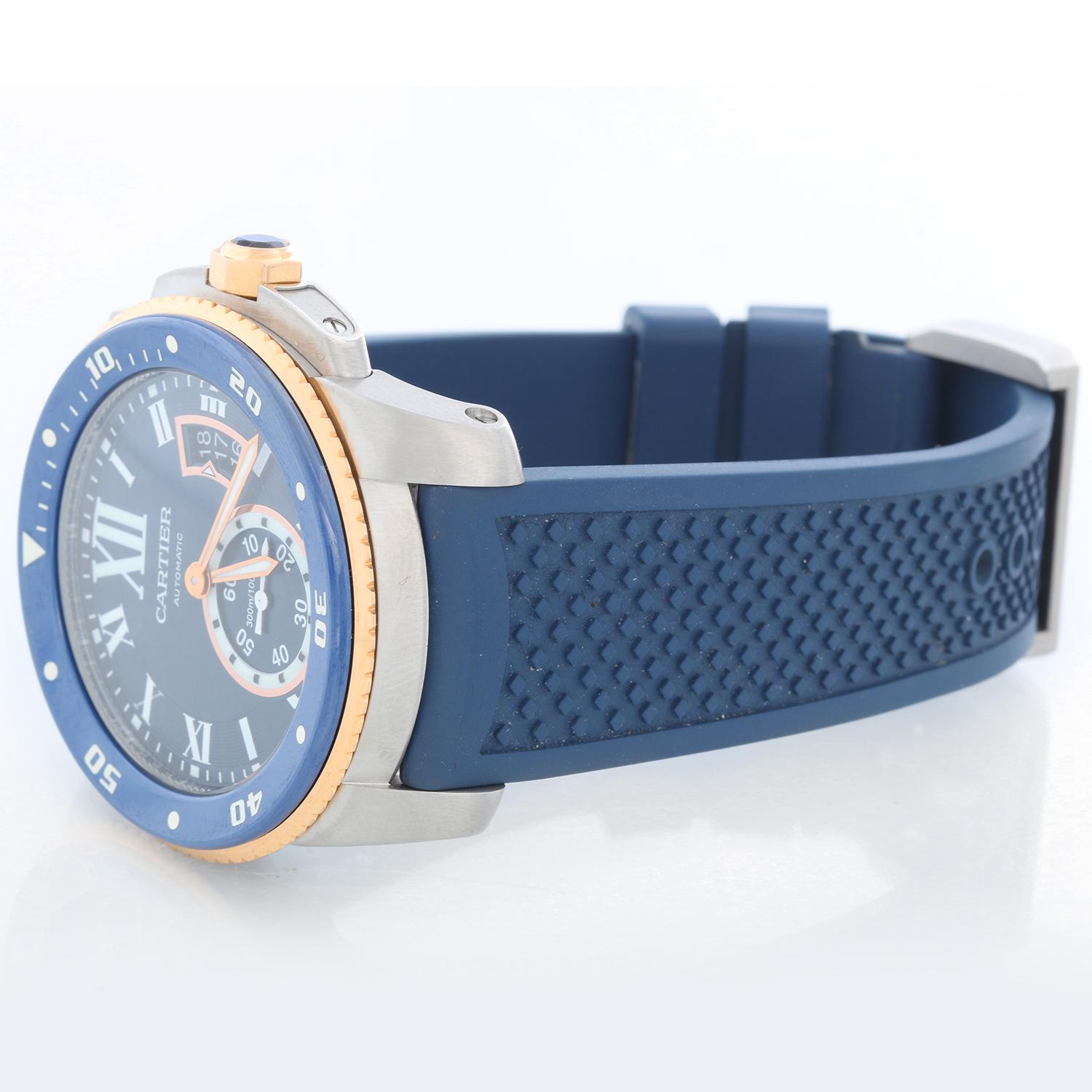 Calibre de Cartier Diver Men's Large 18k Rose Gold & Steel  Watch W2CA0009 - Automatic winding with date. Stainless steel case with 18K Rose gold and blue rotating bezel  (42mm diameter). Blue dial dial with white  Roman numerals and stick markers;