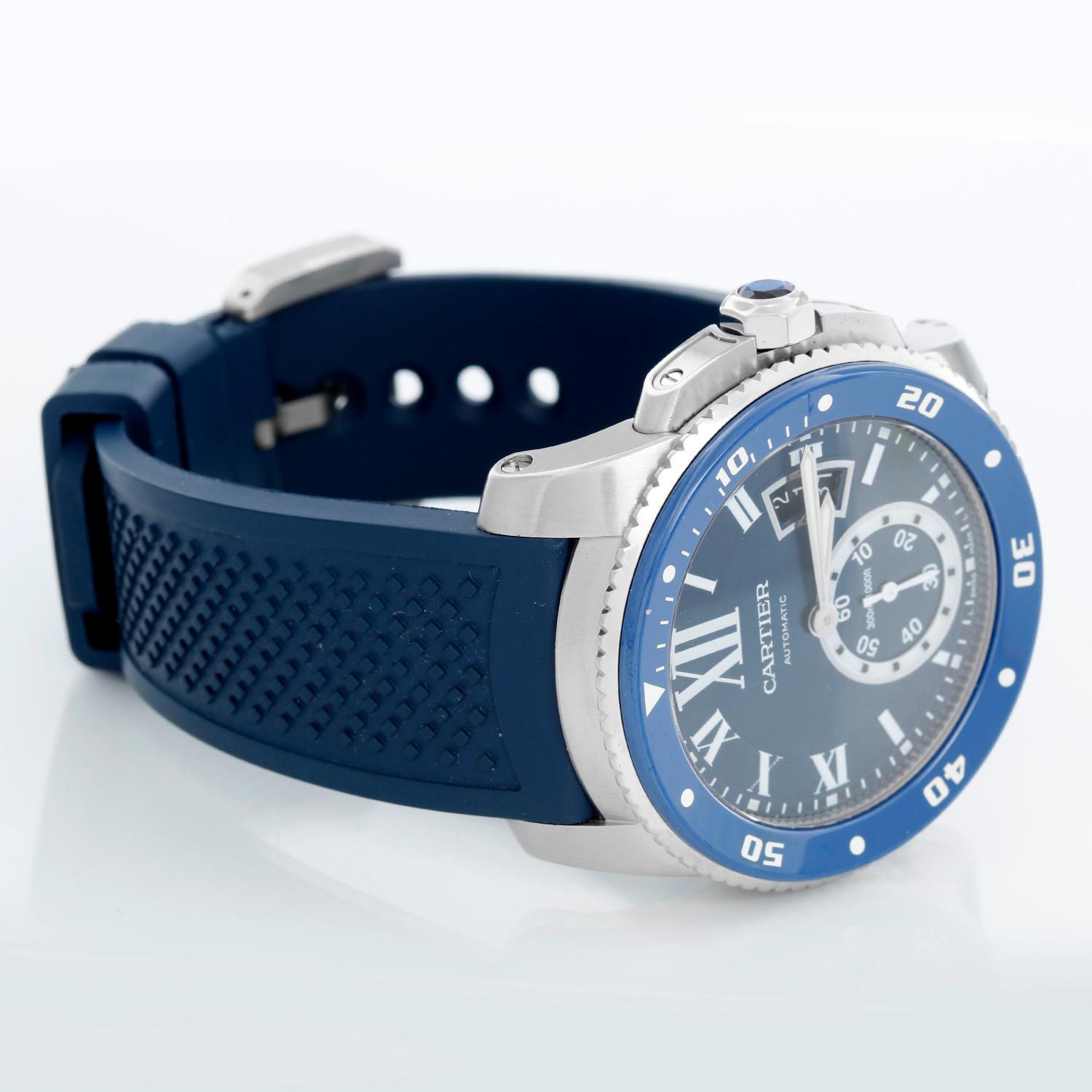 Calibre de Diver Cartier Men's Stainless Steel  Watch WSCA0011 - Automatic winding. Stainless Steel  (42mm diameter). Blue dial with white Roman numerals and stick markers; date at 3 o'clock, subseconds at 6 o'clock. Blue rubber strap with Cartier
