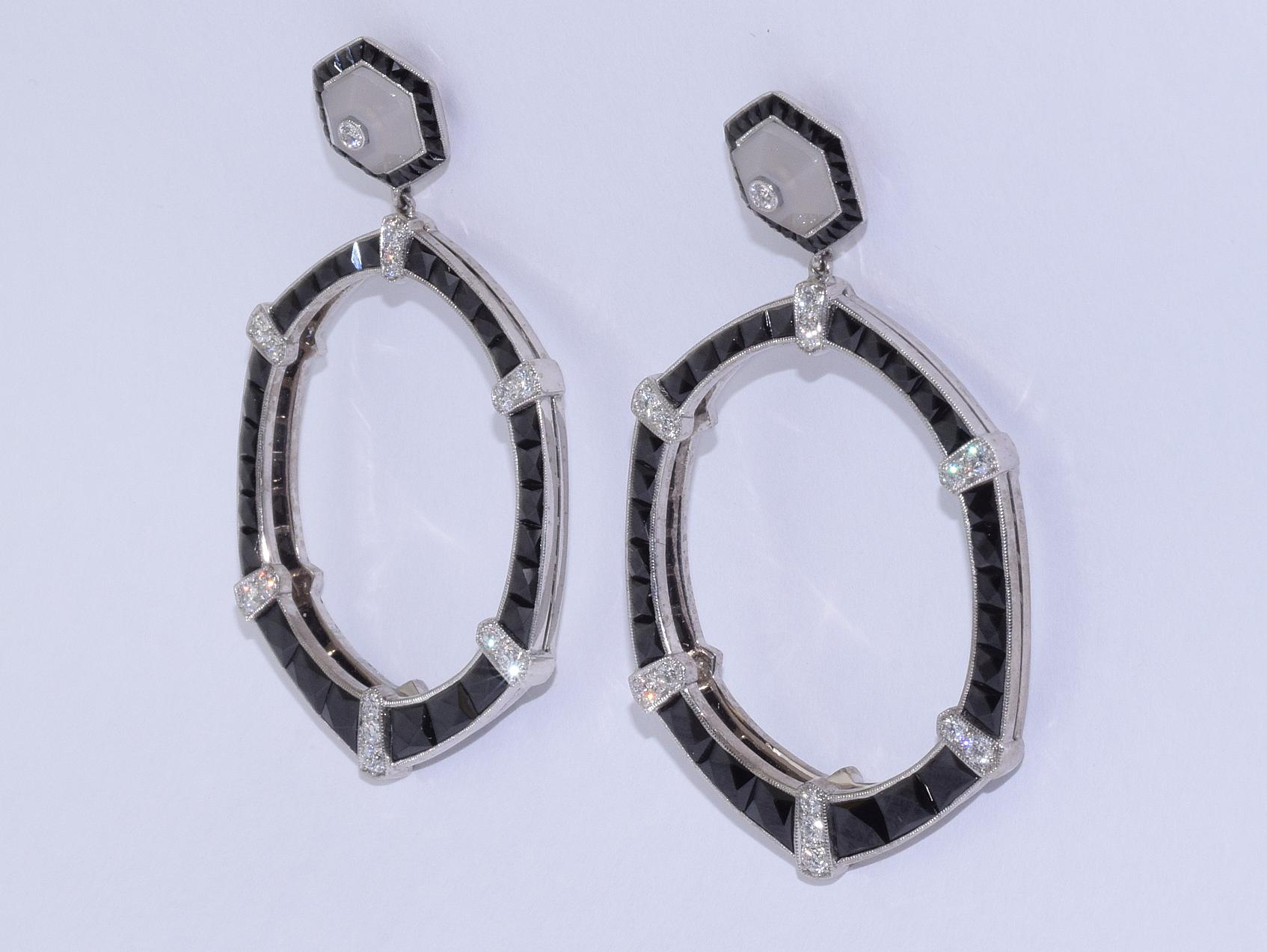 Calibre French cut onyx front facing hoops accented with round diamonds totaling approximately 0.87 carat are suspended from hexagons in grey chalcedony mounted in 18 karat white gold. The earrings measure approximately 2.2 inches in length and are