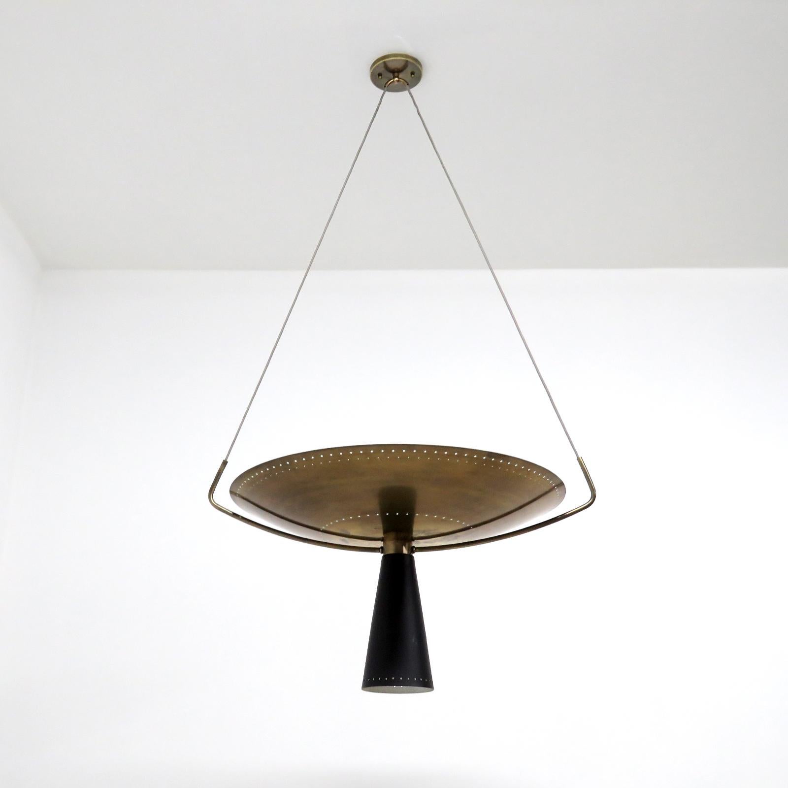 Wonderful two tone pendant light Calice-24 designed by Gallery L7, handcrafted and finished in Los Angeles from American brass, suspended with a perforated, aged brass up-light disc and a black enameled down-light cone. Four E26 sockets per fixture,