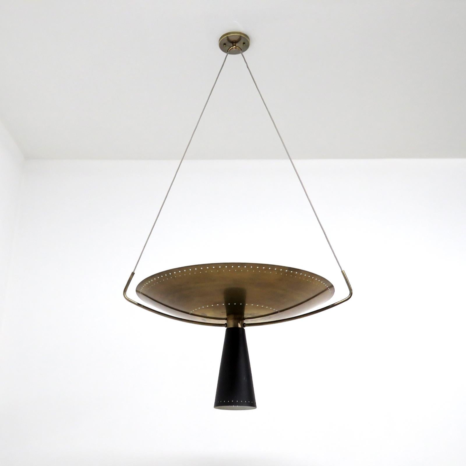 Splendida lampada a sospensione bicolore Calice-24 disegnata da Gallery L7, realizzata e rifinita a mano a Los Angeles in ottone americano, sospesa con una cupola in ottone invecchiato e perforato e un cono in ottone smaltato nero. Quattro prese E26
