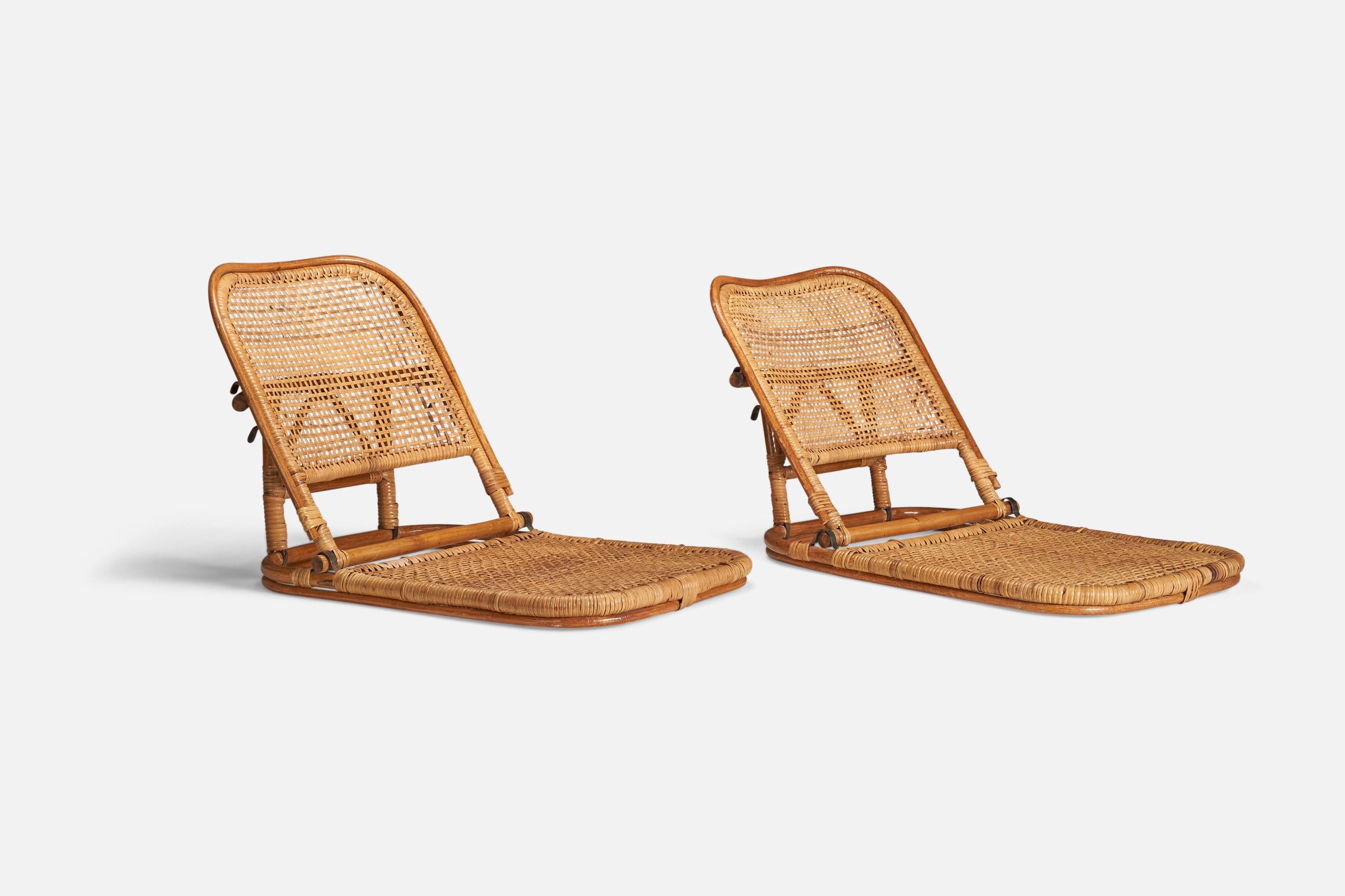A pair of bamboo, rattan and metal folding lounge chairs designed and produced in the USA, 1950s.

Measurements listed are of chair in its most upright position.

Measurements of the chair in its most reclined position (inches) : 16.37 x 17.87 x