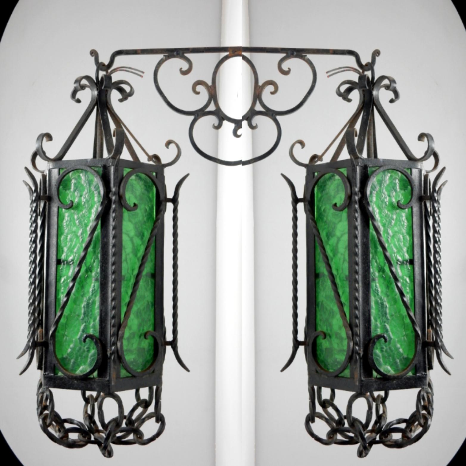 Pair of ornate wrought iron garden/patio sconces.
6 sided with original emerald green wavy glass,
Circa 1950's.
  