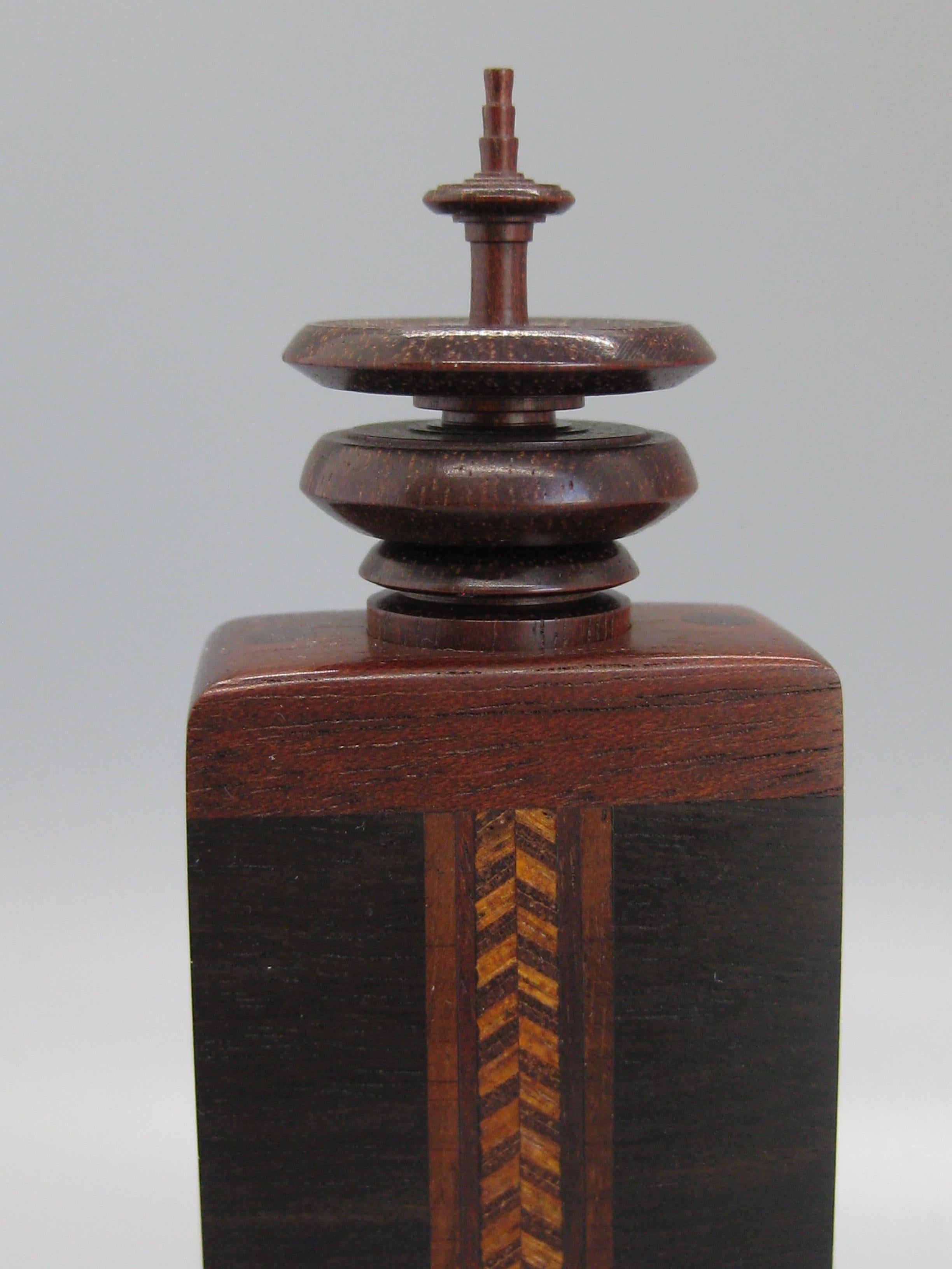 Wonderful handcrafted wooden perfume bottle/stash box made by California Artist Stephen Mark Paulsen. It dates from 1981. Signed by the artist on the bottom. Made of mainly cocobolo wood and rosewood. Top is turned and has a glass bottle inside. His