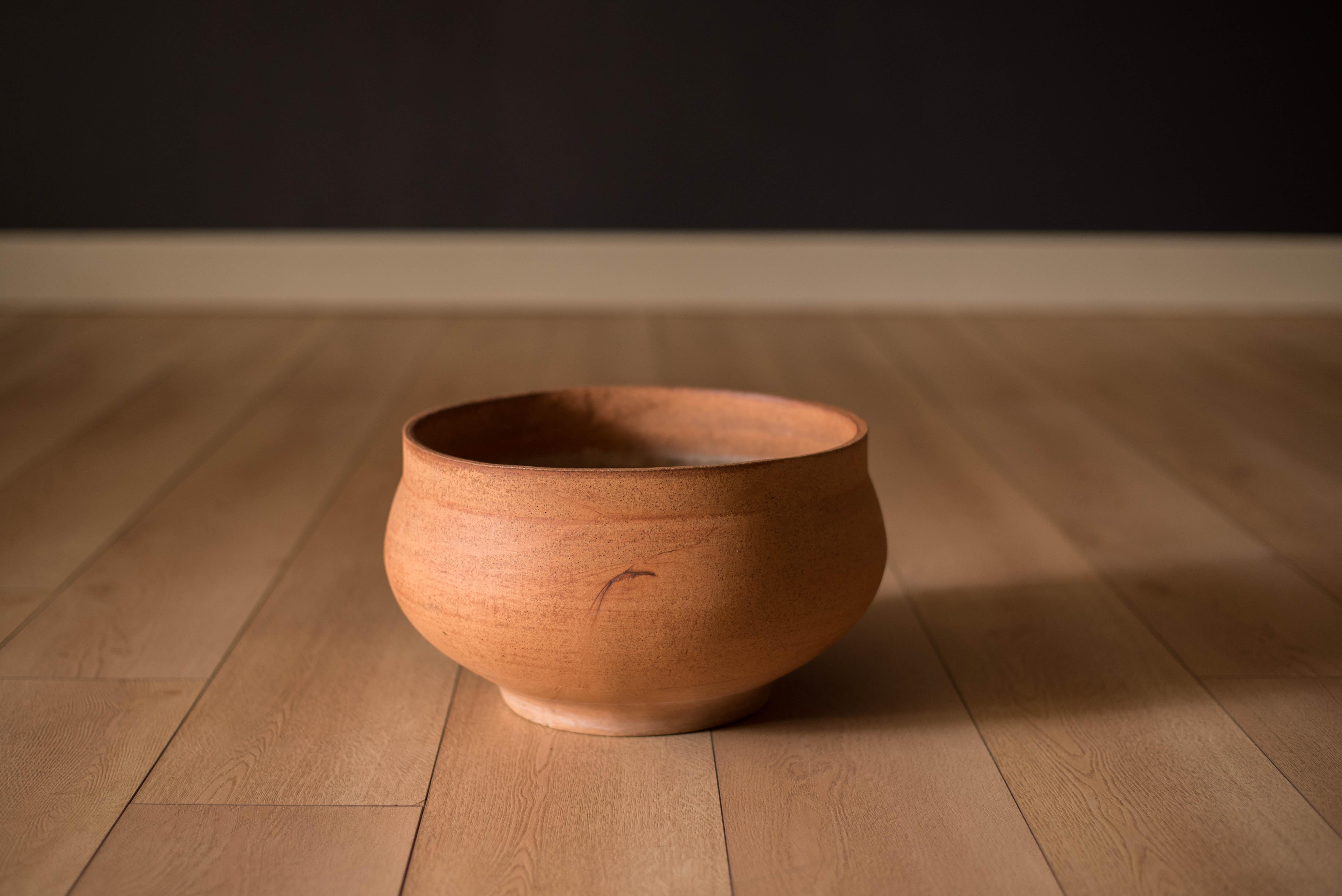 Mid-Century Modern ceramic planter pot designed by David Cressey for Architectural Pottery Pro/Artisan. This hand poured stoneware vessel features a mixture of natural clay earth tones fired with an unglazed textural finish and distinctive markings.