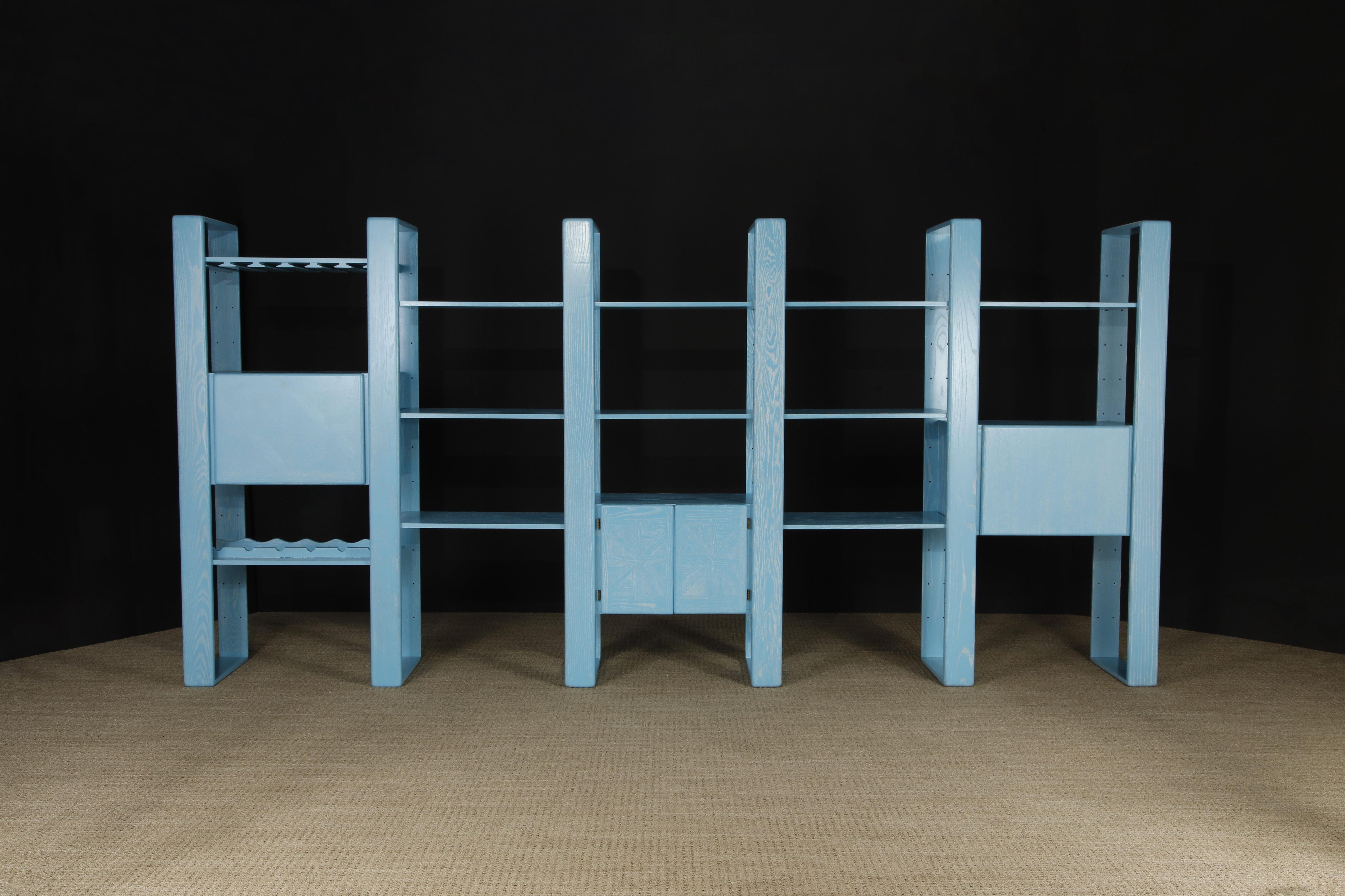 This 80's light blue cerused oak modular wall bookcase, which is finished on the back so can also be used as a floating room divider, is by Lou Hodges and was designed and produced in California in the 1970s and 1980s. You can configure this modular