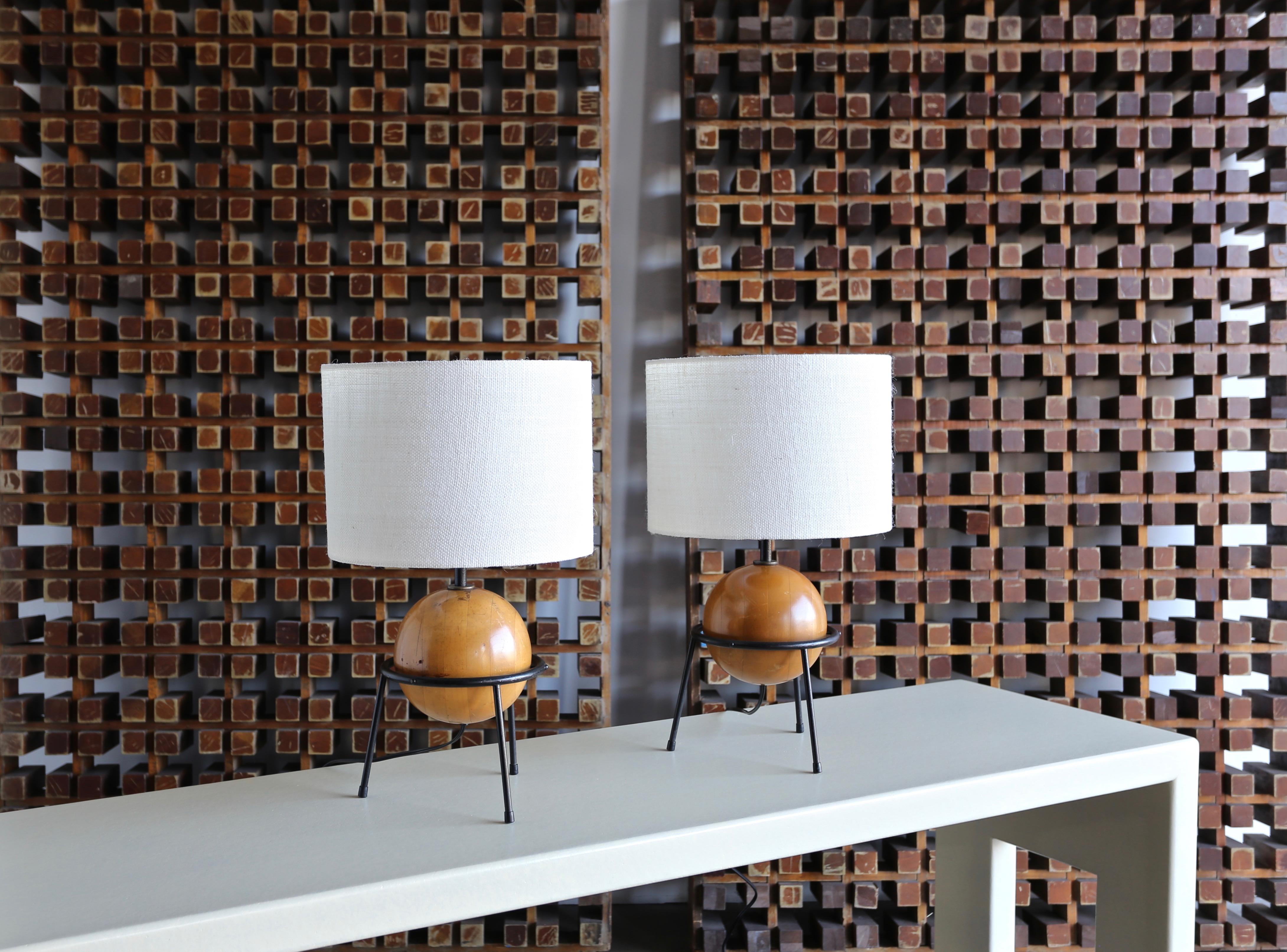 California Modern lamps by Albert Blake. Iron frame with a floating solid wood sphere. Produced in limited quantities by Blake’s company.

Like many designers of the period, Al Blake moved from the Midwest to California after serving in the Army