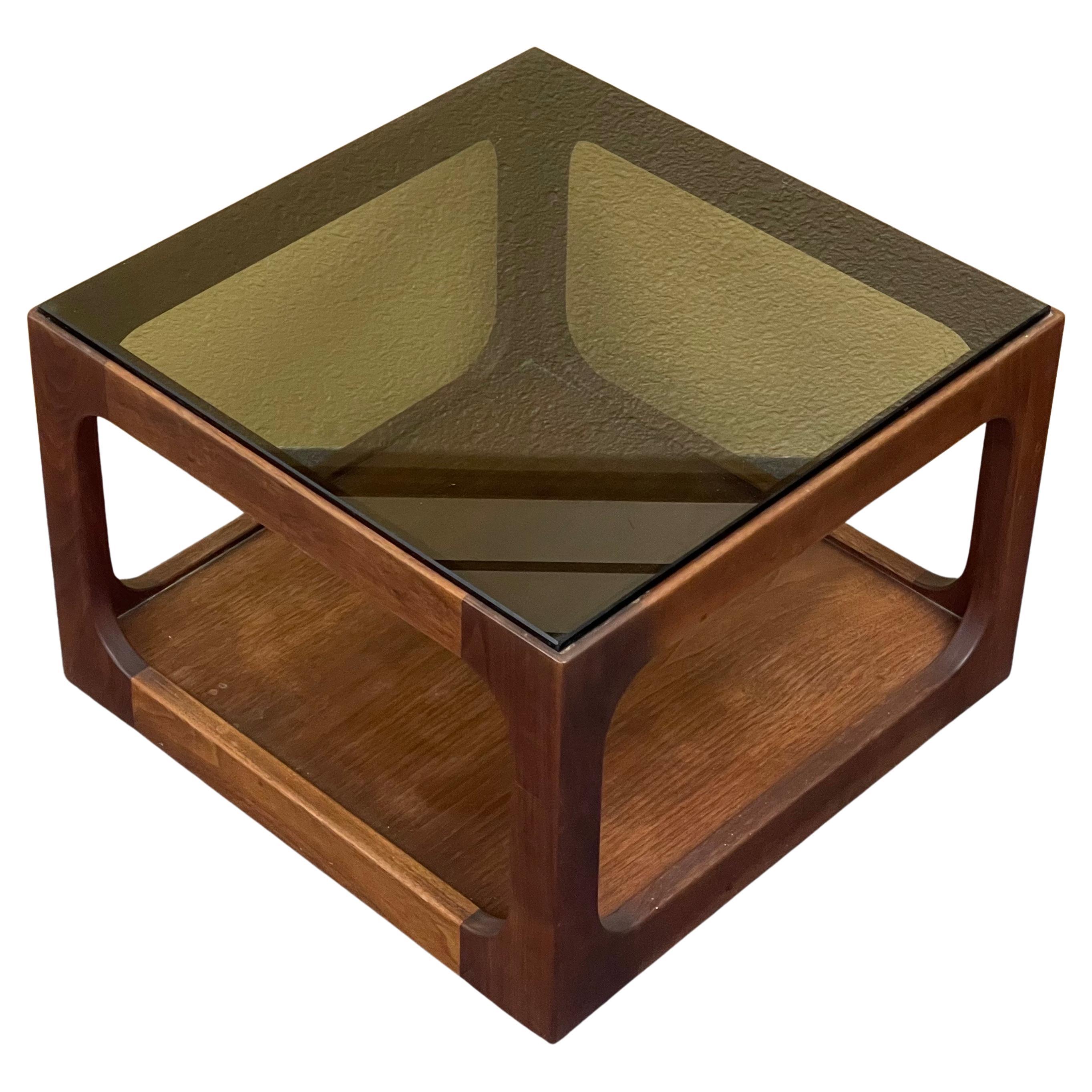 Single smoked glass end / accent table with walnut frame designed by John Keal for Brown Saltman, circa 1970s. The table is in very good vintage condition, measures 18
