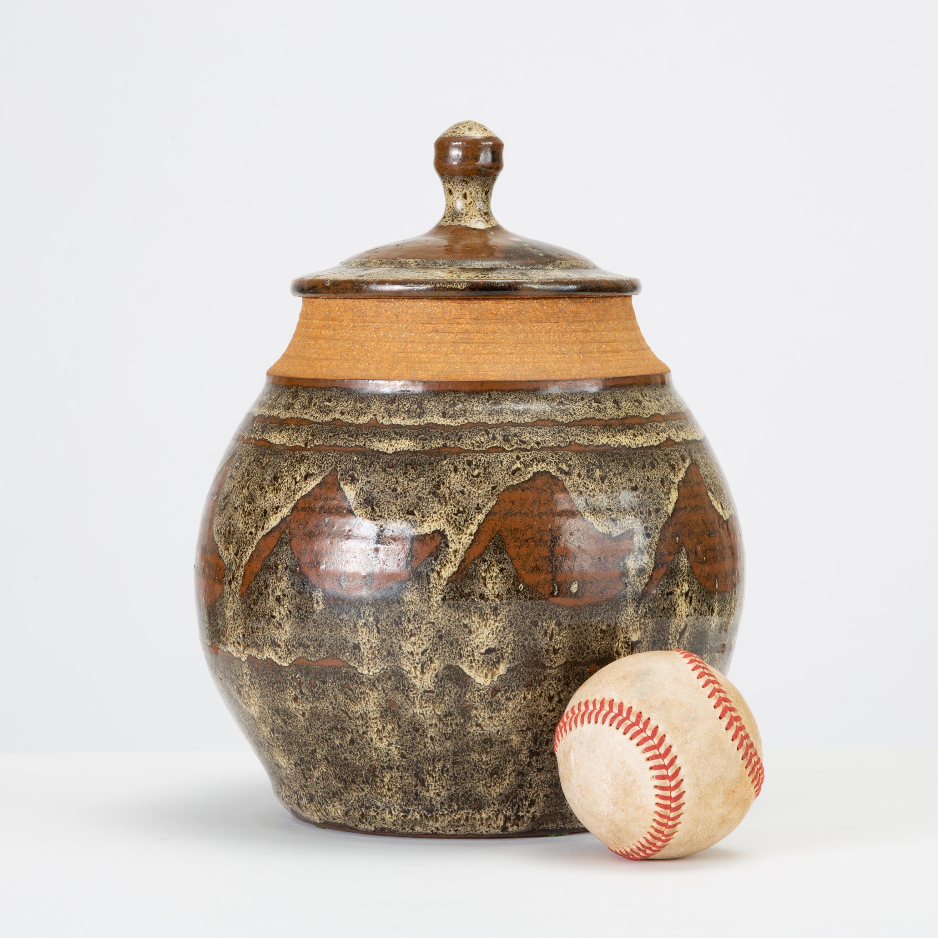 Don Jennings, a prominent local ceramicist based in orange County, California, worked as instructor and artist throughout the 1960s and 1970s. This example is a wheel-thrown ceramic lidded jar with an abstract pattern in high-gloss glaze - a