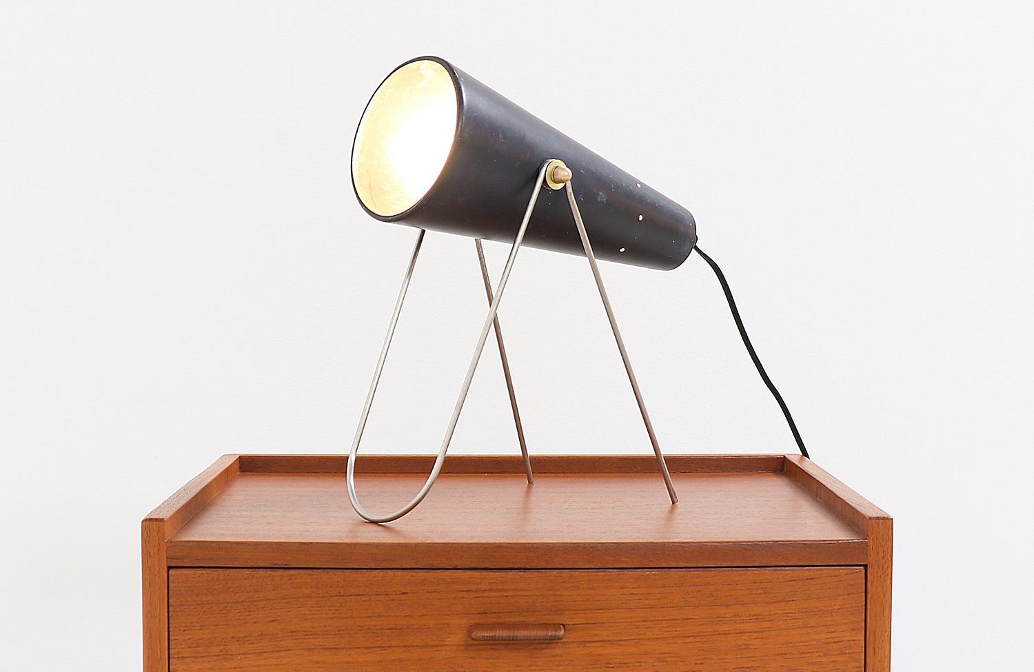 Stylish table lamp by Los Angeles based designer, Vincent Cilurzo, circa 1950s. Featuring a black enamel metal cone shade that tilts up and down to help function as a spot or directional light. Supported by its wire metal base to help float the cone