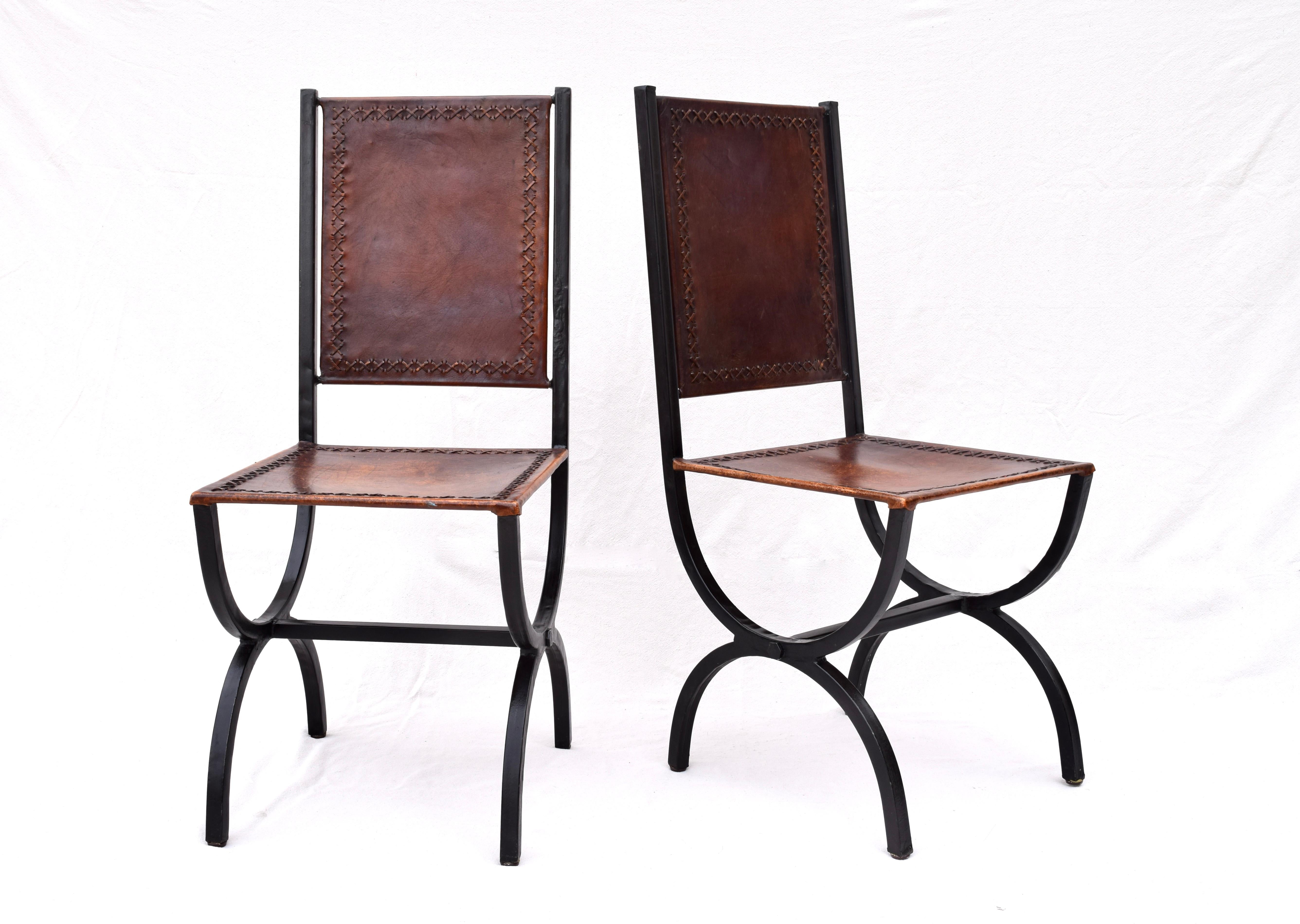 California Napa style brand Iron and leather Curule form dining chairs of rustic style steel and leather with intentionally distressed thick rawhide cross stitch detailing. Very solid and well made, originally purchased in 2008 from California