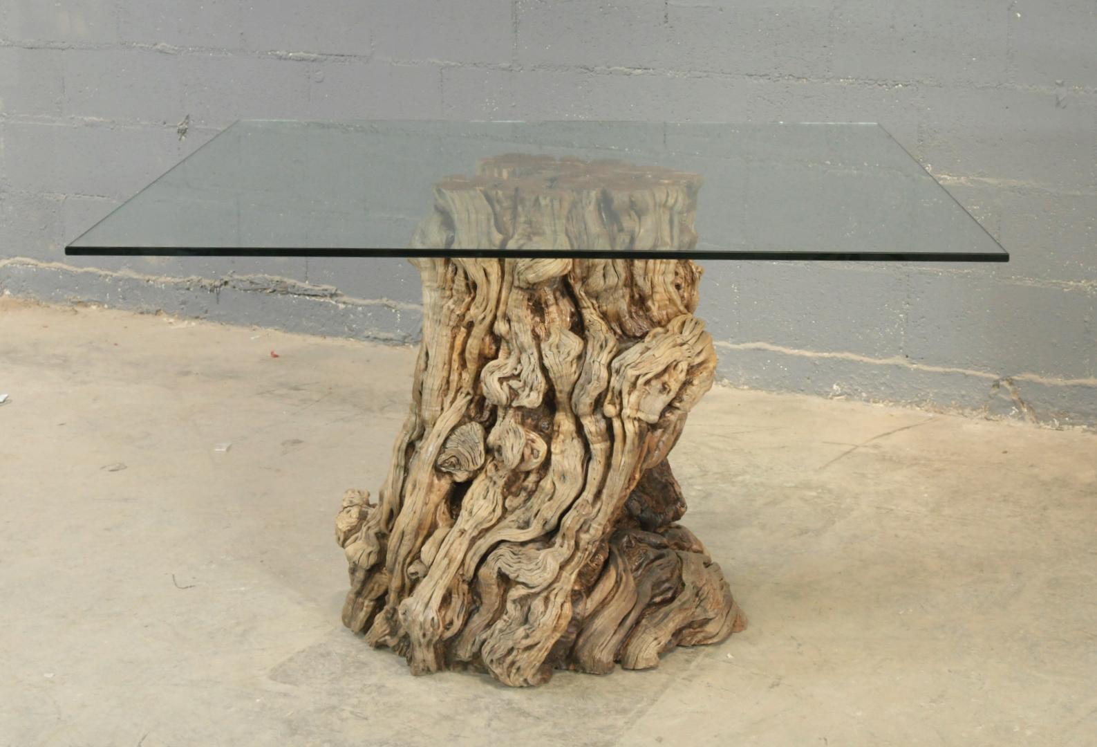 This stump from a California pepper tree has been naturally seasoned over 100 years. 

It can be purchased with the glass to be used as a coffee table, or without the glass to be used as a side table. 

There are a few stumps to choose from of