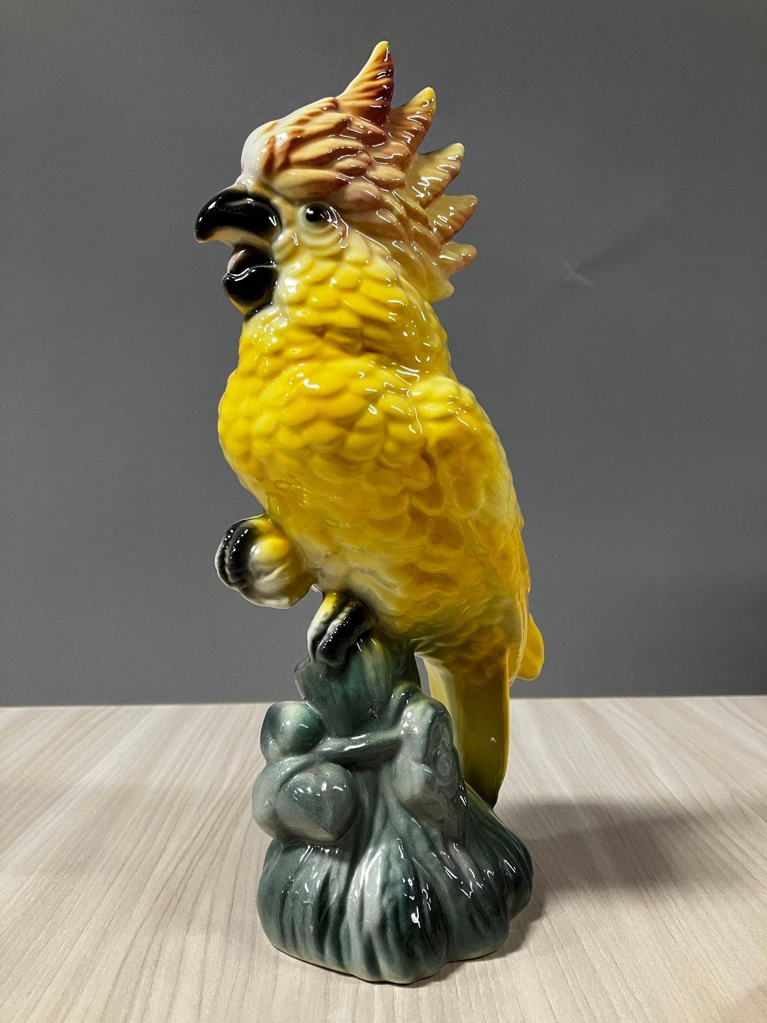 Early Mid-Century Ceramic Tropical yellow colored Cockatoo on a Branch by Fame California Potter William Maddux.

A great example of Hawaiian mania that swept the USA After WWII with many American troopers fighting on the Pacific front bringing the