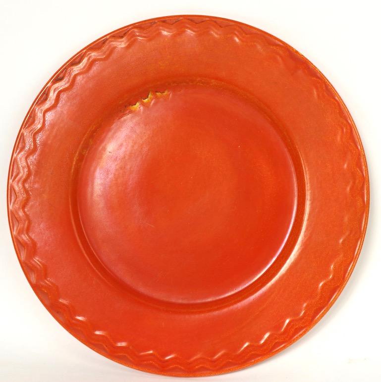 Classic California orange glaze ceramic chop plate, possibly Pacific, or Catalina Pottery, unsigned. Matte finish with decorative geometric edging. Nice large size, great original condition, free of damage or repairs.