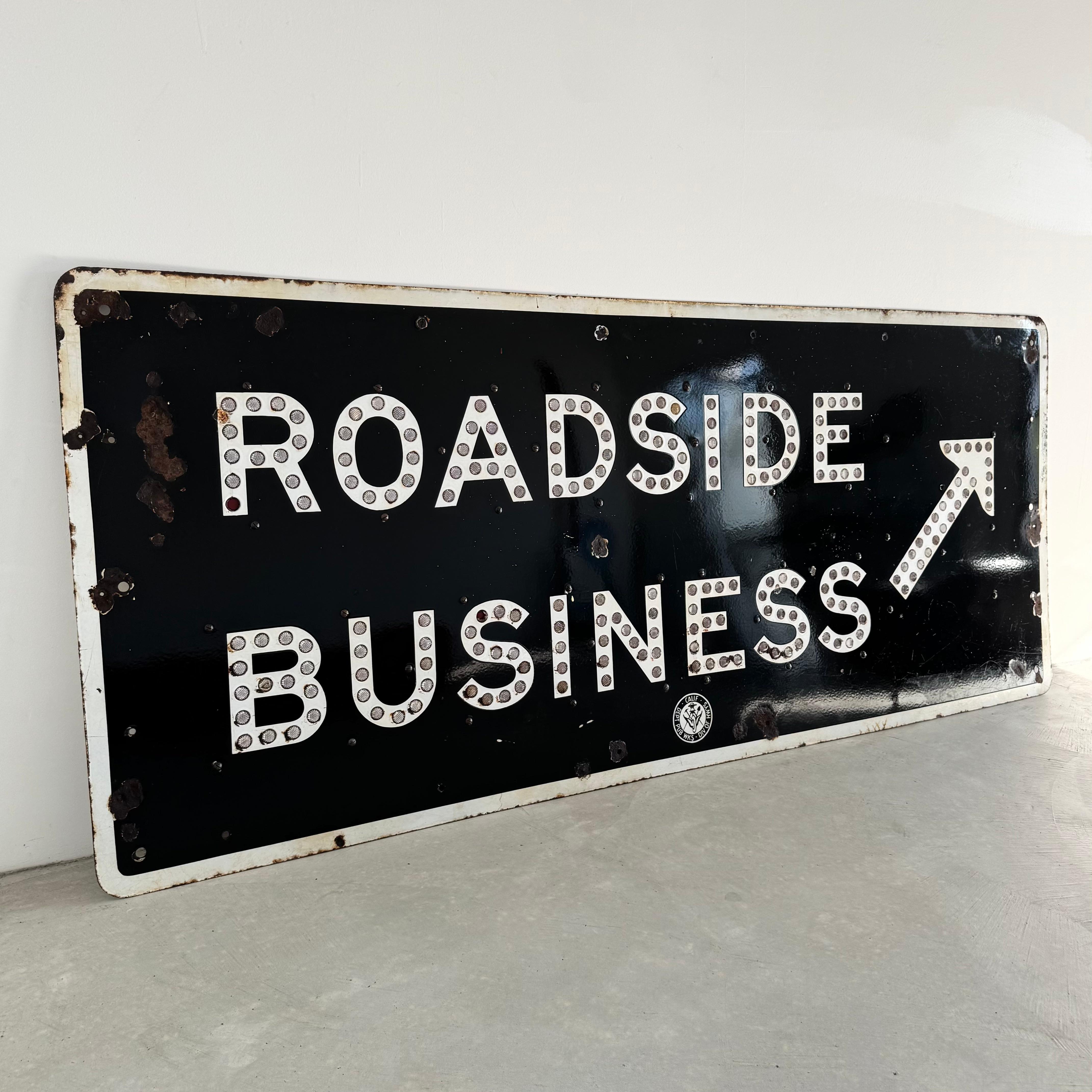 Take a trip drown memory lane with this 1950s California freeway sign. Taken down from Nothern California decades ago, the sign features a black background with white lettering and cats eyes reflectors. Produced by the California Department of