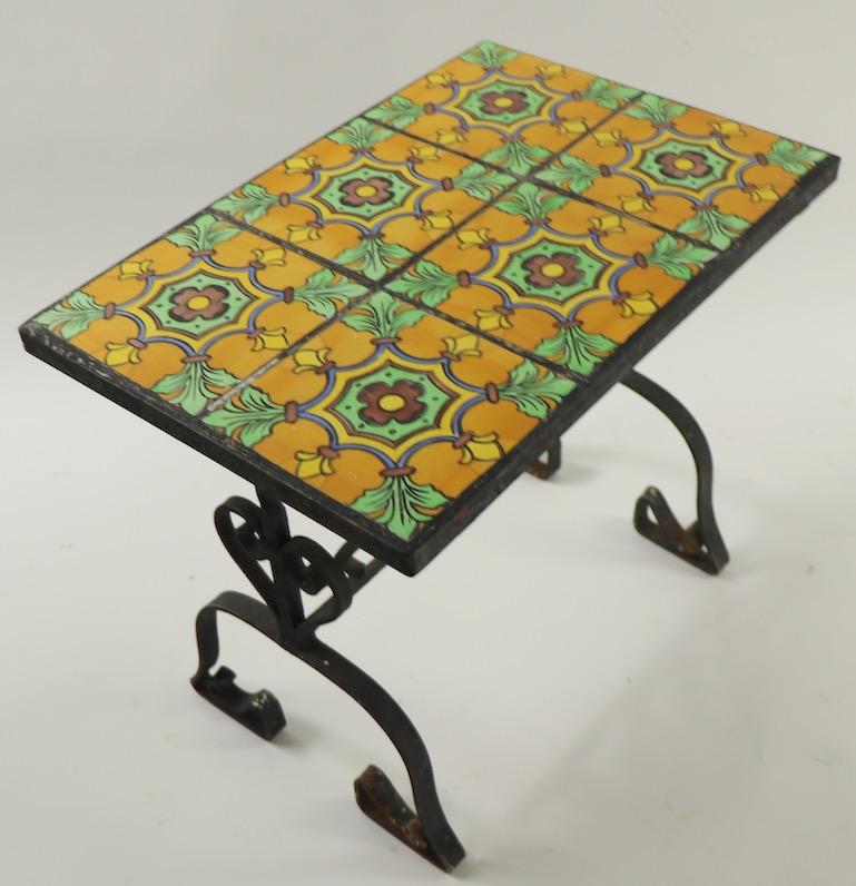 Arts & Crafts Gothic Revival wrought iron base table with 6 square pottery tiles comprising the top. Classic California Catalina School tiles, well detailed and wrought metalwork base. Very fine, original condition, showing only expected light wear