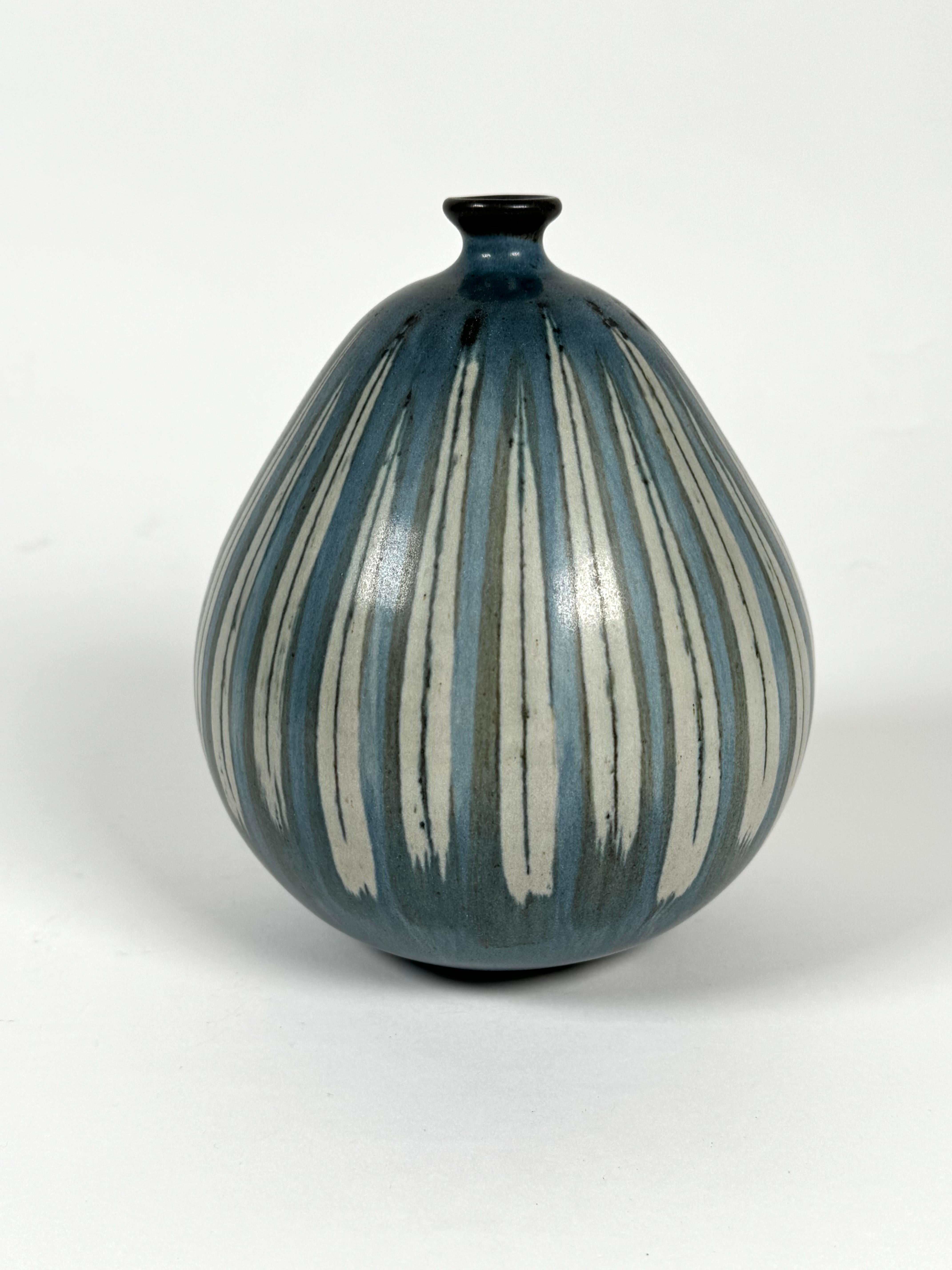 California studio ceramic artist Rupert Deese (1924-2010). Bulbous ceramic vase with blue tones with striped patterned glaze embellishments. Deese was a noted ceramicist who won numerous awards over the course of his career.