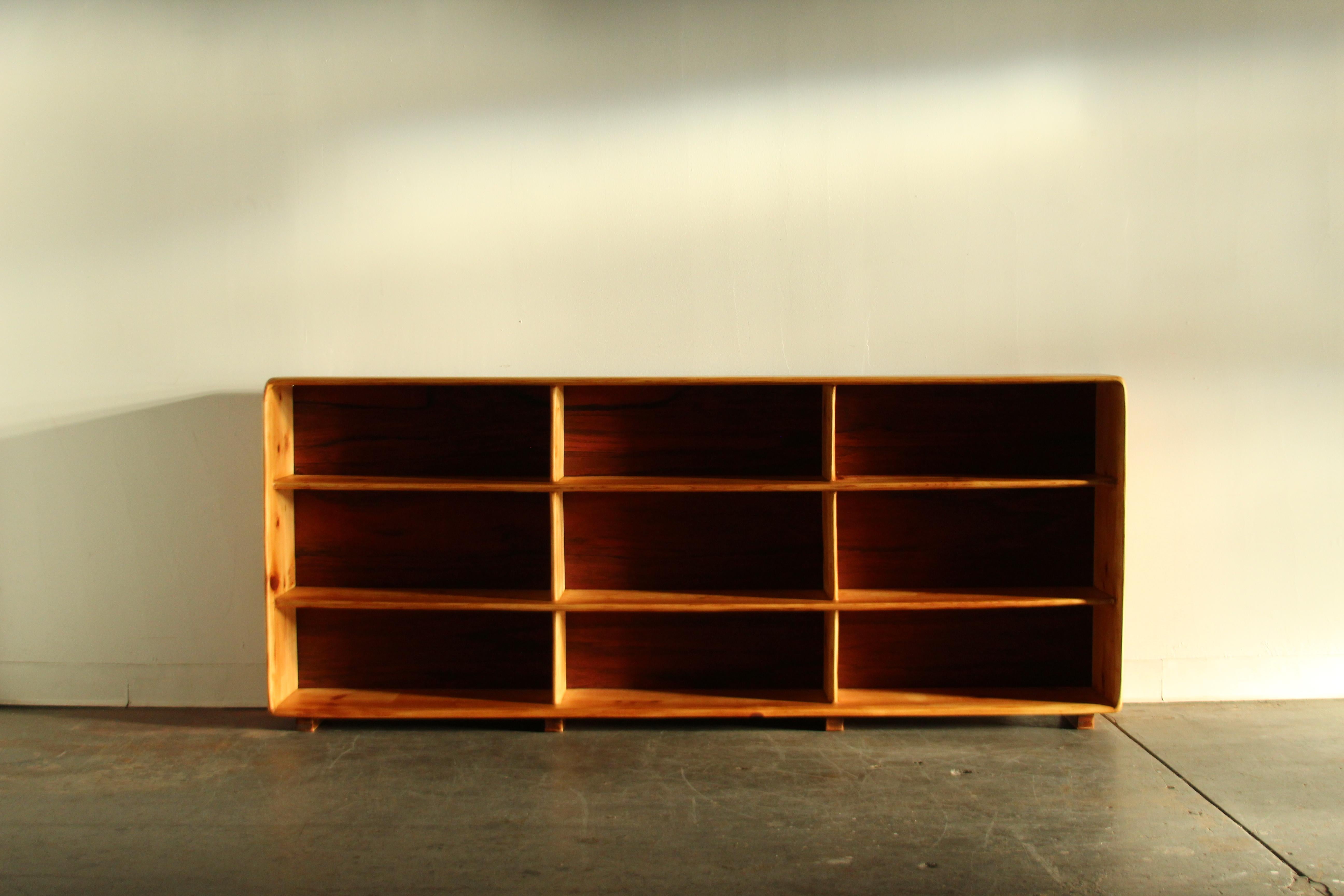 An amazing California studio crafted bookcase constructed in solid pine with rosewood veneer backing, most likely made in the the 1970s. Every corner and edge has been sculpted to create an organic, sinuous aesthetic. The piece has an incredible