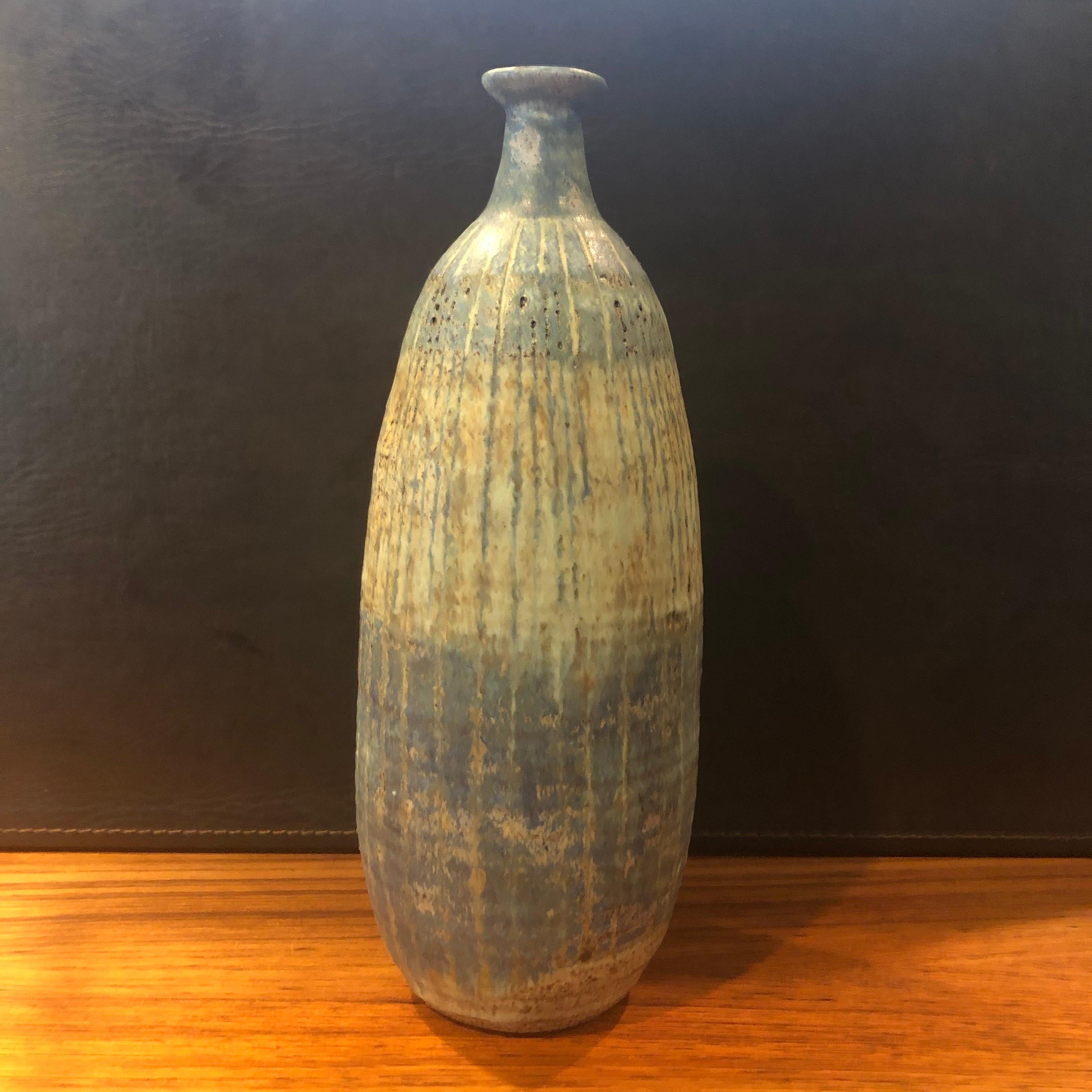 A very nice California studio pottery ceramic vase with beautiful blue, tan and brown earth tones by Helen Noel Shagam, circa 1963. The vessel has a wonderful design, look and form. #1244.

 