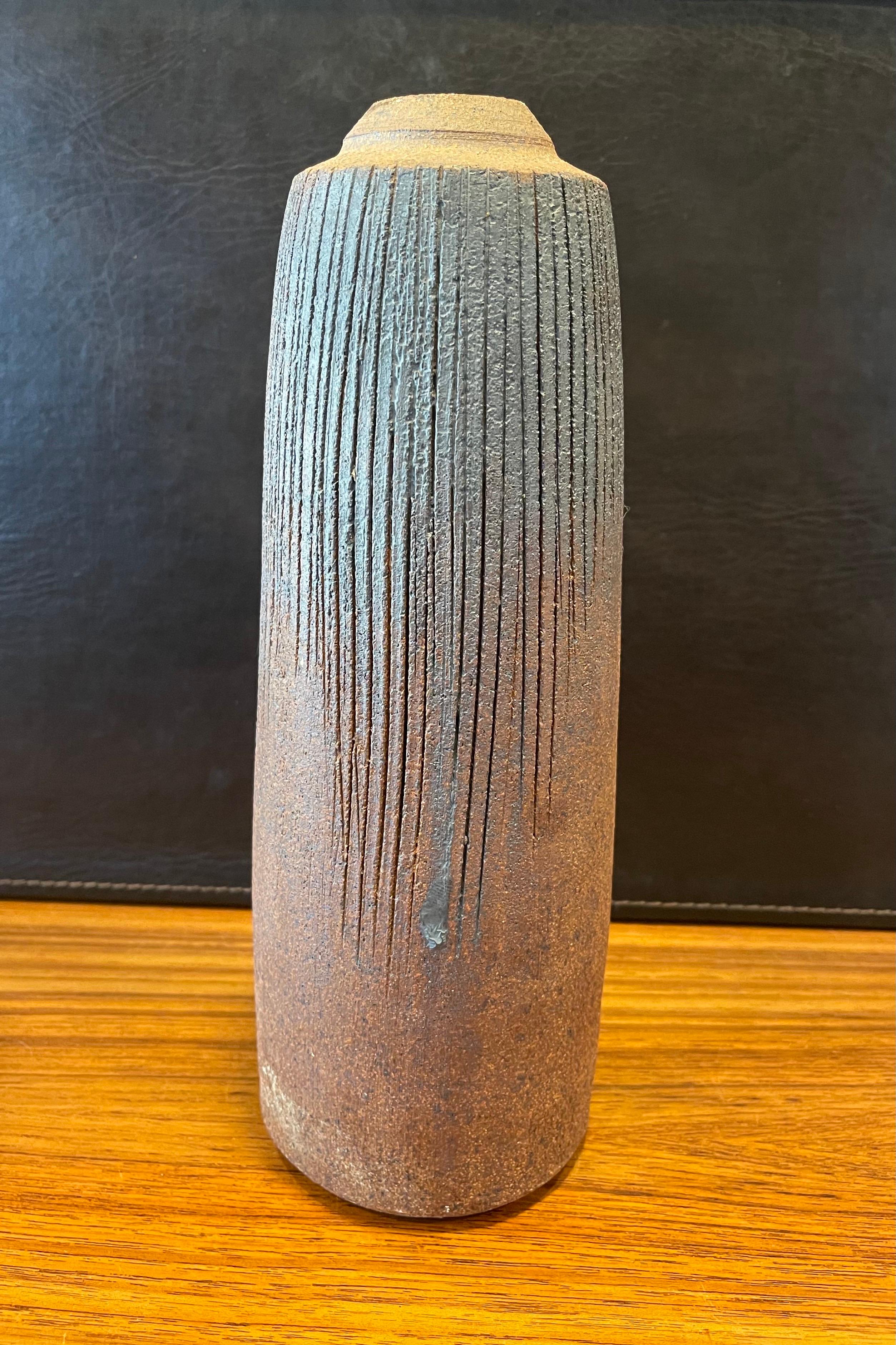 A very nice California studio pottery earthenware vase with beautiful grayish blue, tan and brown earth tones, circa 1970s. The vase has a wonderful design, look and form and is signed 