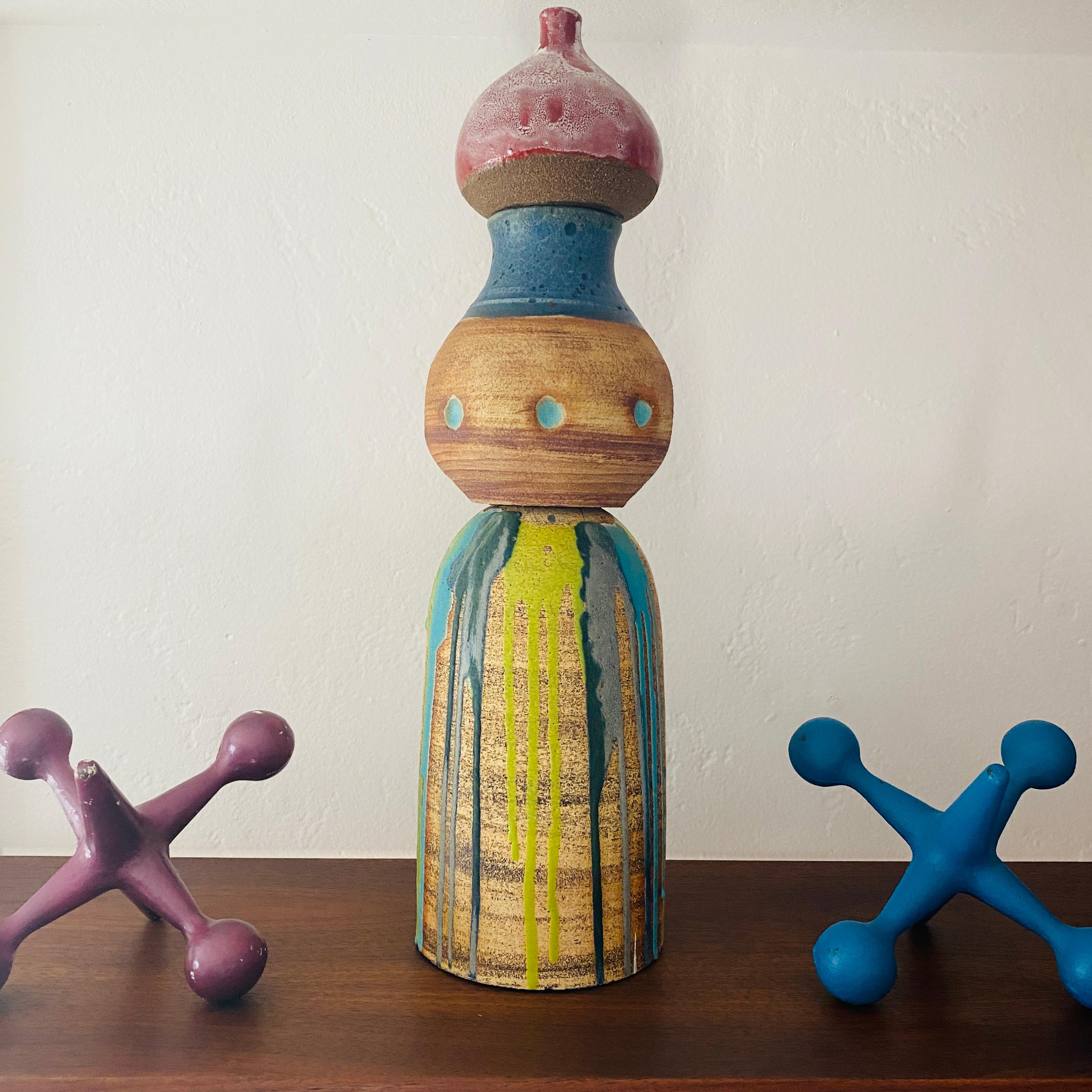 This is a colorful sculptural vase made in California by Michael 