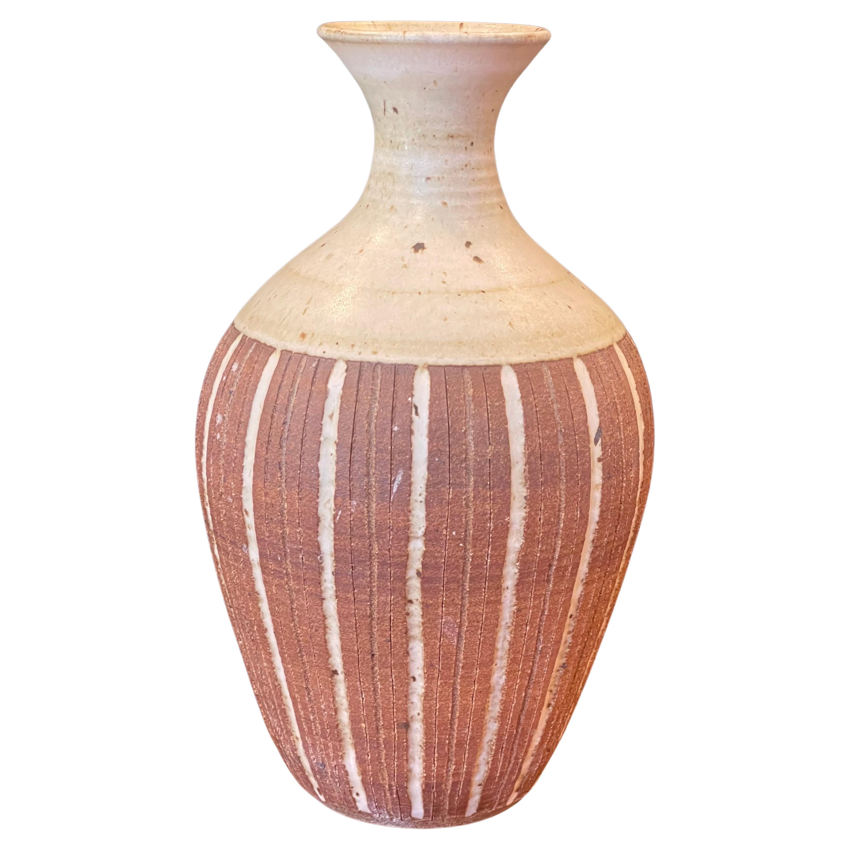 A very nice California studio pottery stoneware vase with beautiful tan and brown earth tones by San Diego artist Barbara Moorehead, circa 1970s. The vessel is in good vintage condition with the exception of one small chip on the lip (please see