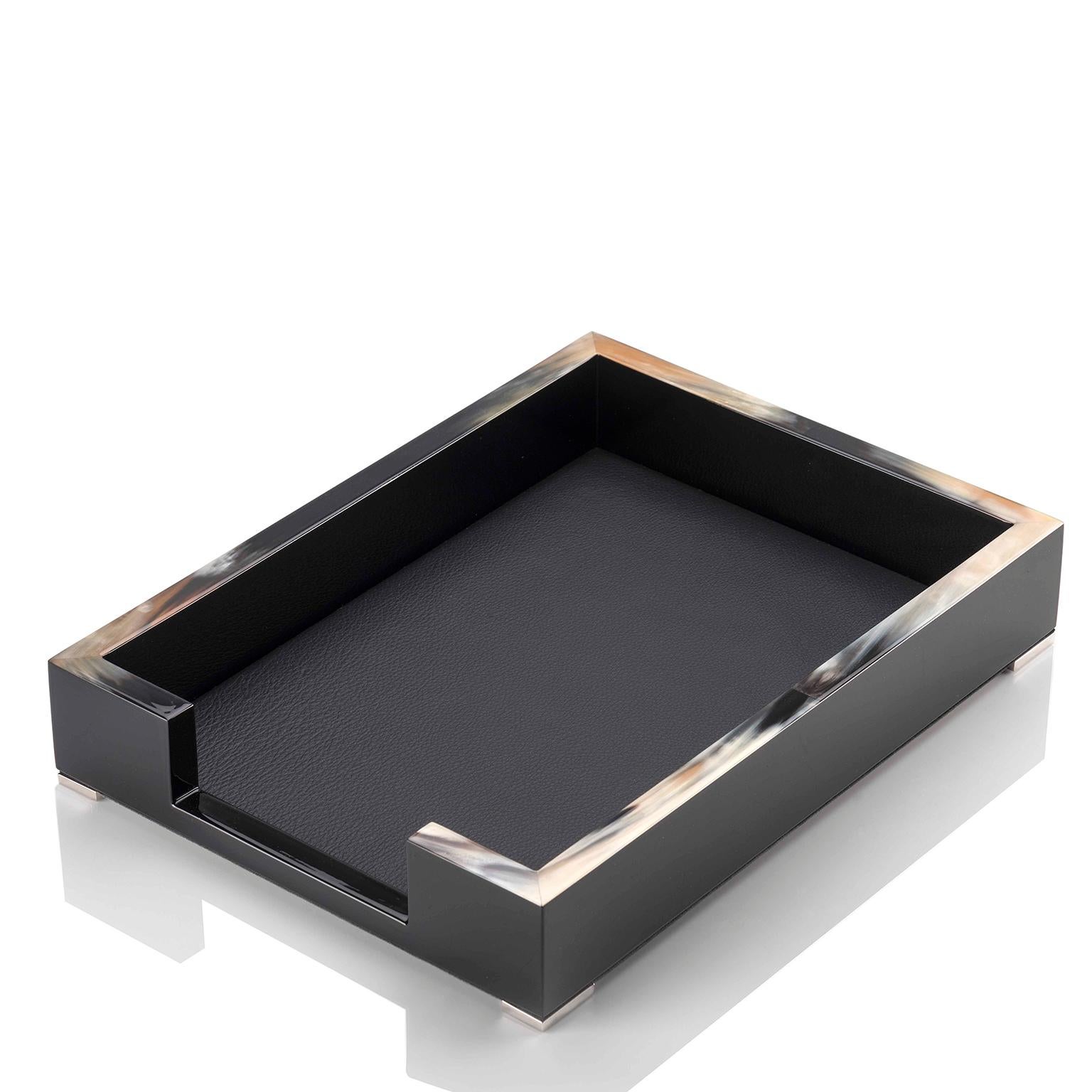 Perfect to store paperwork on your desk, the Calipso A4 paper tray is imbued with textural beauty. Crafted in glossy black lacquered wood, the design is added an elegant allure by beautiful details in Corno Italiano. Featuring a precious internal