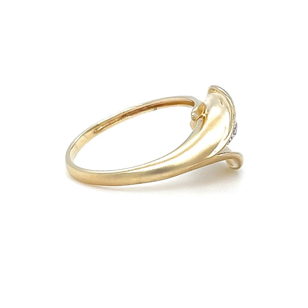 14 karat yellow gold matte finish calla lily wrap ring featuring 30 single cut diamonds of SI clarity and I color totaling approximately 0.15 carats. 
Finger size 7.
Finished weight is 2.9 grams

This stunning gold ring features a unique calla lily