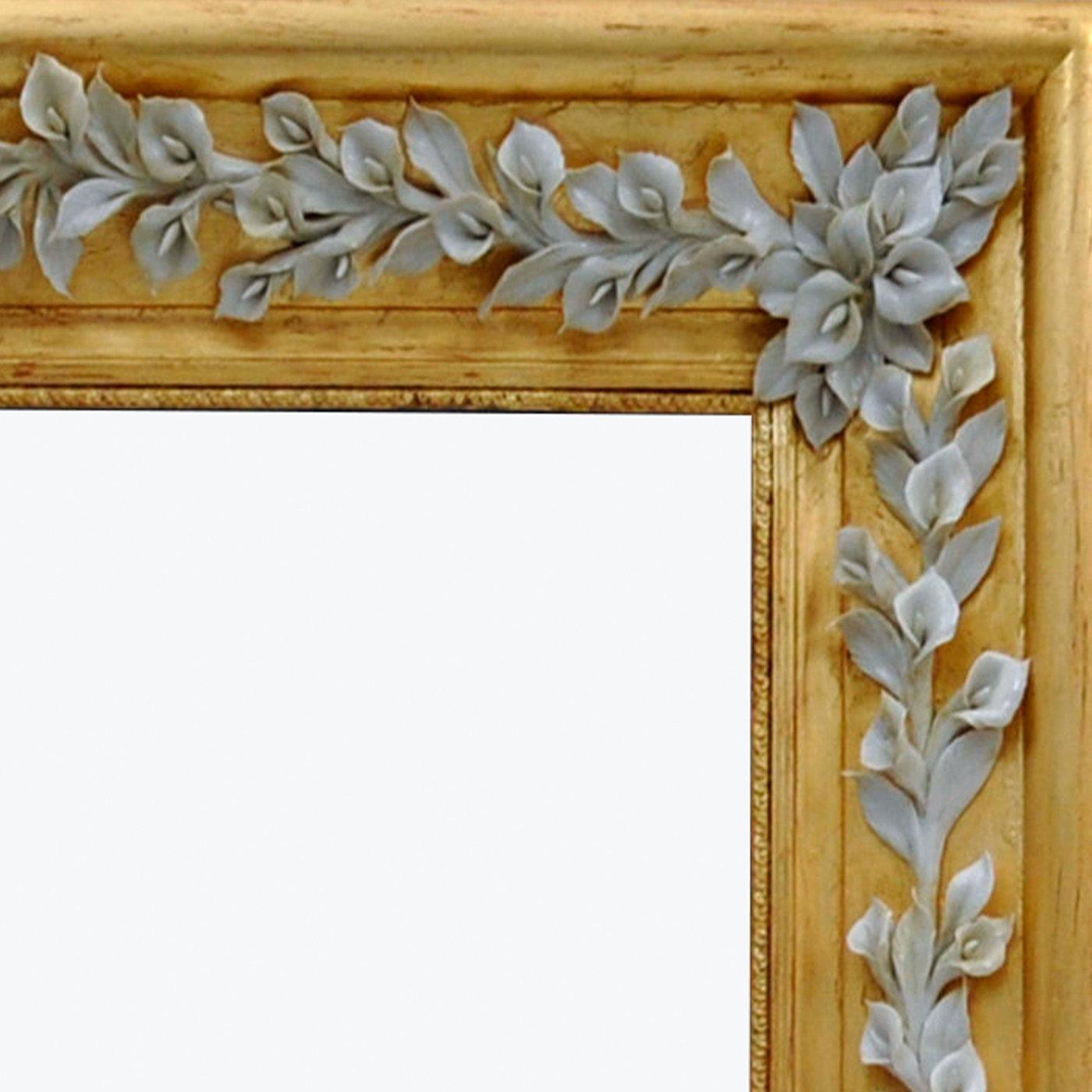 Recalling a garden in bloom, the sleek and sophisticated sides of this rectangular frame mirror are exquisitely decorated with an exceptional floral composition handcrafted of fine Capodimonte porcelain. Handcrafted of wood enhanced with a golden