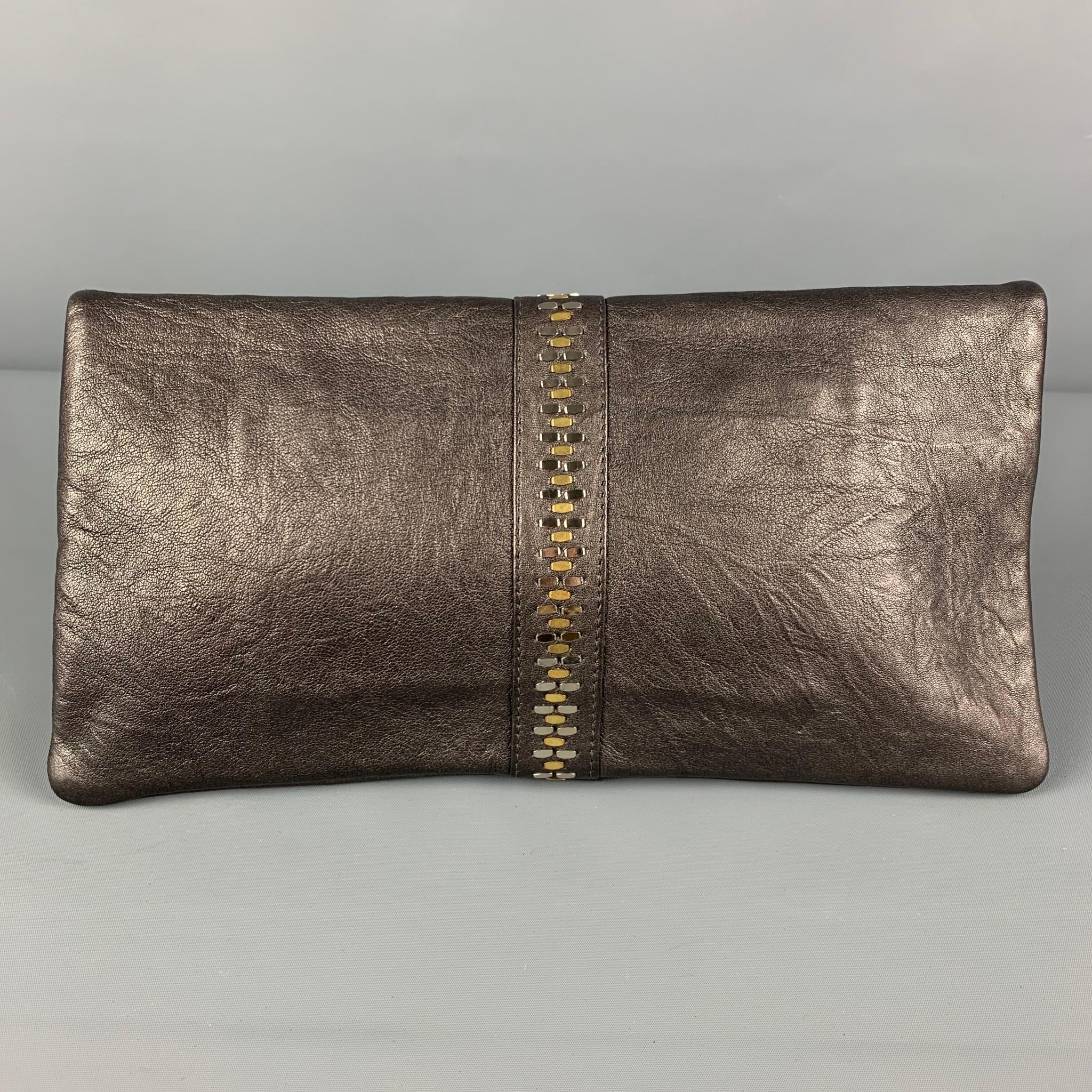 CALLEEN CORDERO clutch comes in a grey leather featuring studded details, inner pocket, and a magnetic closure. 

Very Good Pre-Owned Condition.

Measurements:

Length: 13 in.
Height: 6.5 in.