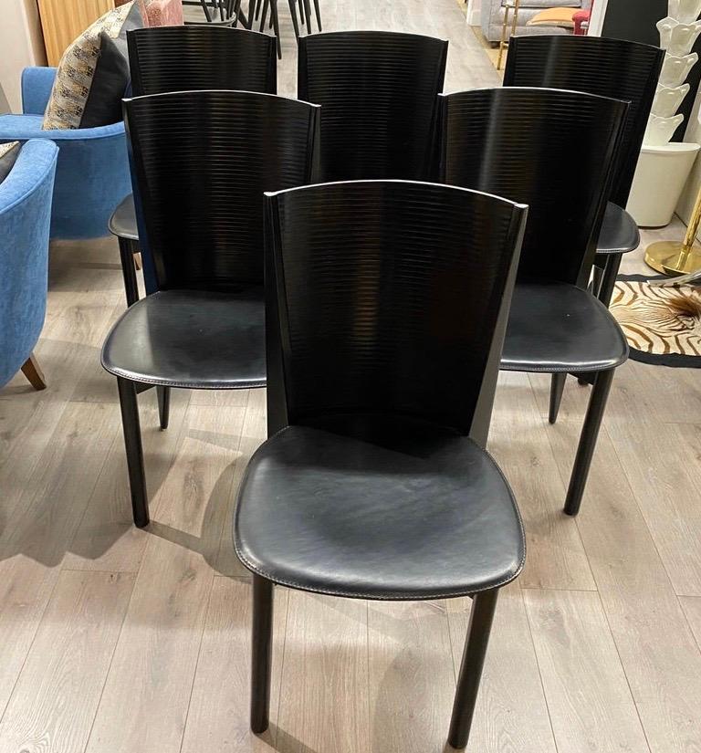 Elegant set of black Calligaris dining chairs. Made of feather, resin and textile, these chairs have great
scale and better lines. The color is black and all have Calligaris hallmarks on bottom. Iconic and sleek.