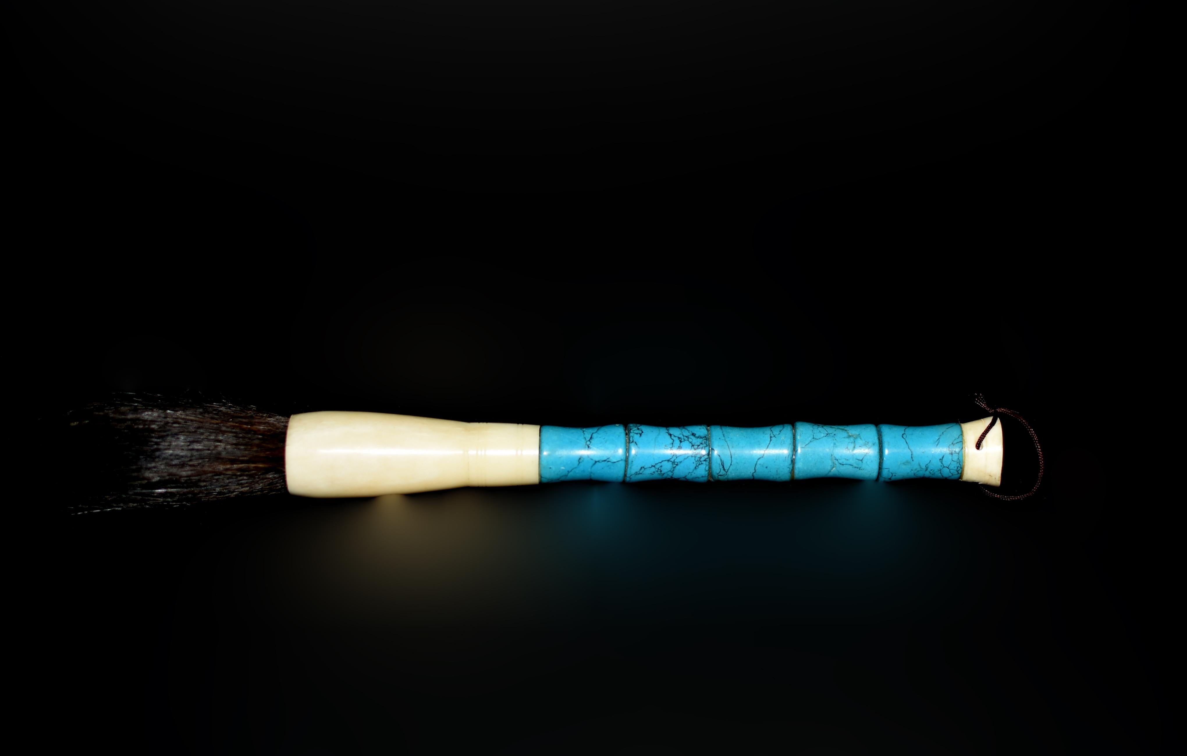 This calligraphy brush is distinguished by its faux turquoise handle. Hand cut and polished, exhibiting a beautiful turquoise color with naturalistic black veining, very much approximating the appearance of genuine turquoise. The brush is fitted