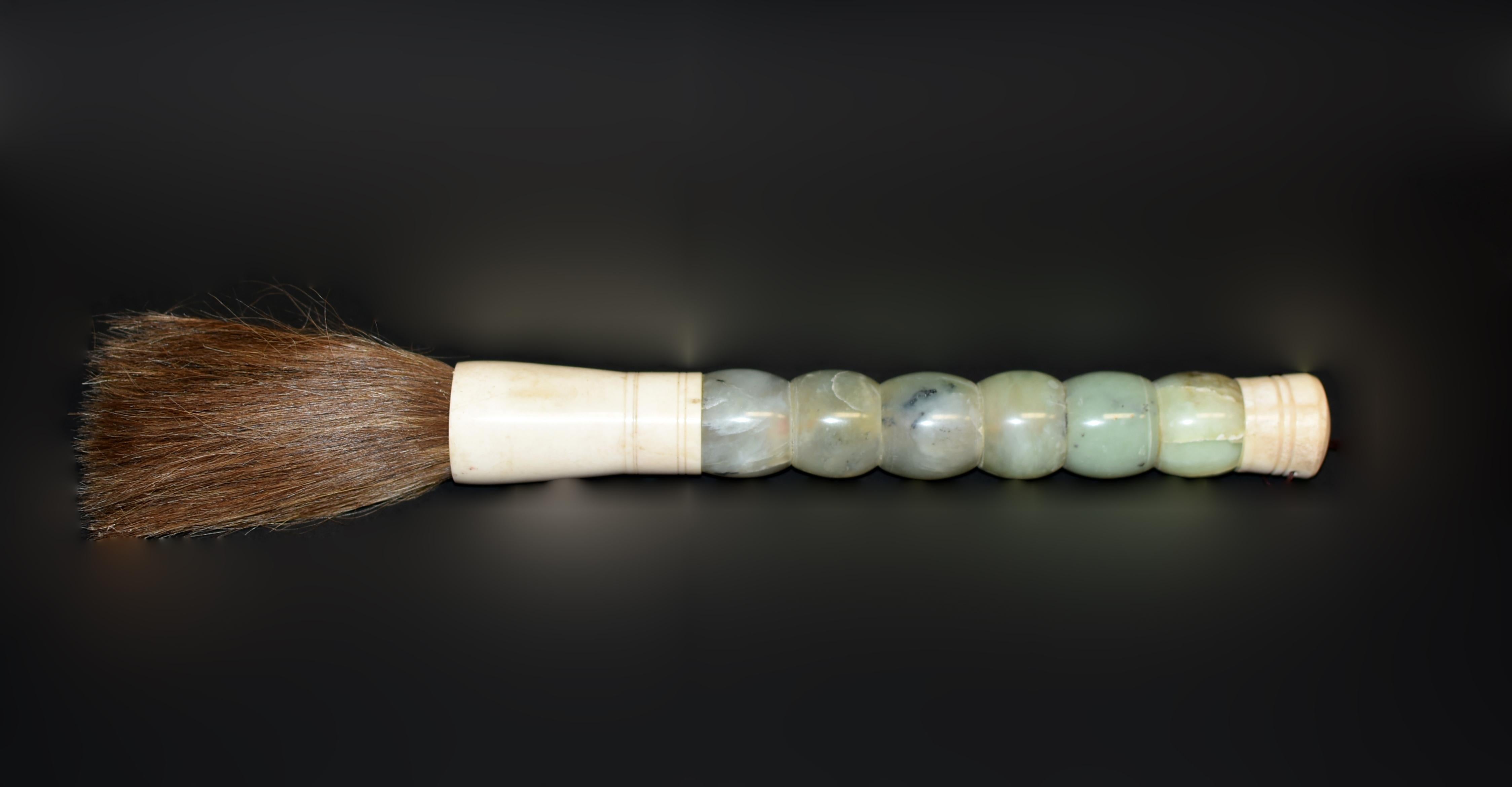 A testament to traditional craftsmanship, this large Chinese calligraphy brush is skillfully handcrafted with beautiful large serpentine barrel beads. The carefully chosen gemstone serpentine used in its construction features natural inclusions,
