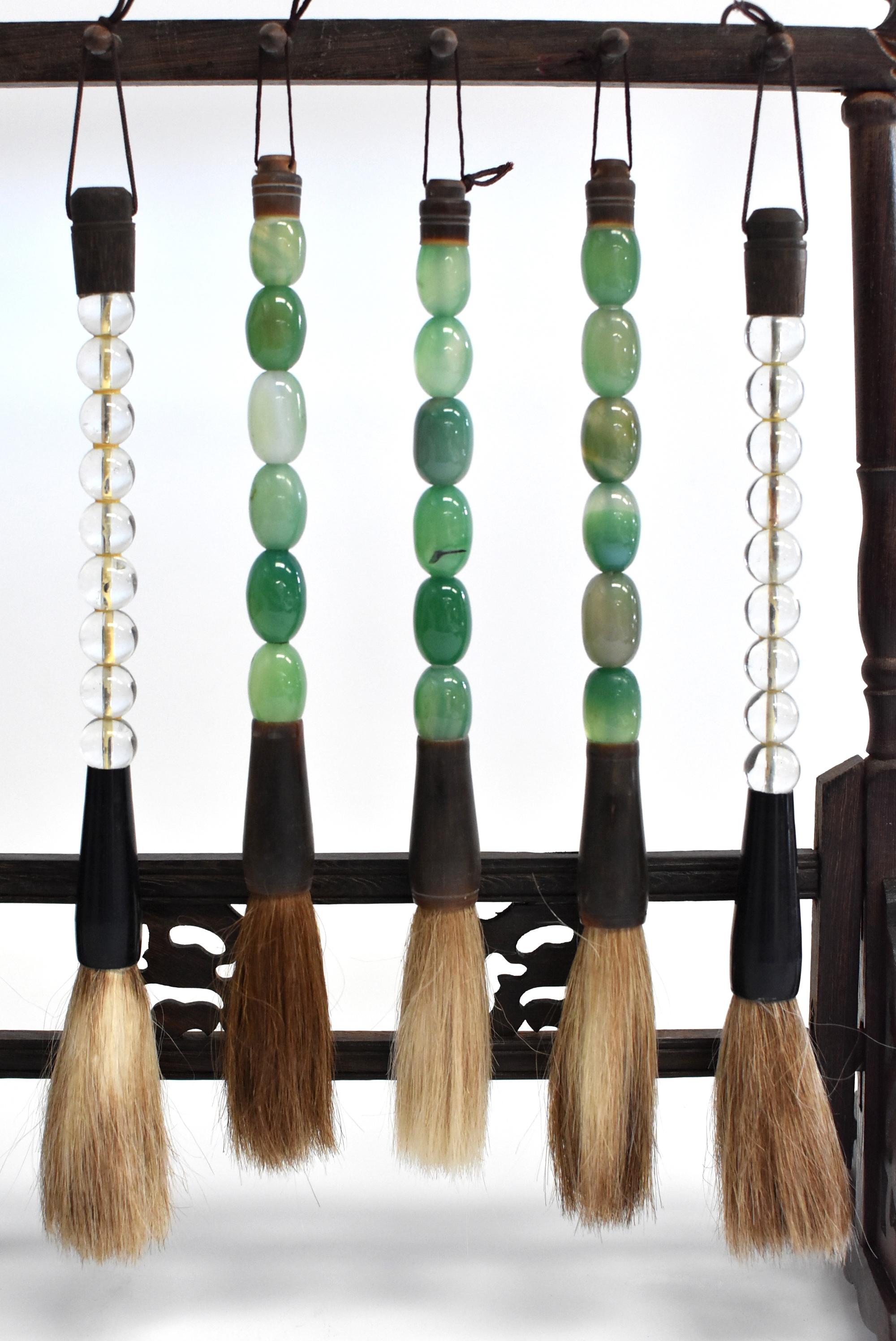 Beautiful set of 5 Chinese calligraphy brushes with glass-bead handles. The green glass brushes have beautiful natural buffalo Horn ferrule. Brushes are handmade with horse hair. Stand not included but available for purchase in our store front.