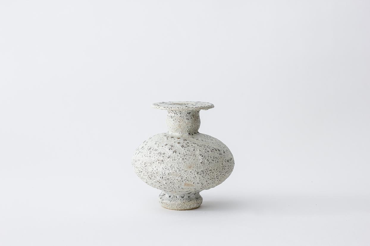 Cálpide granito stoneware vase by Raquel Vidal and Pedro Paz
Dimensions: 16 x 16 cm
Materials: Hand-sculpted, glazed pottery

The pieces are hand built white stoneware with grog, and brushed with experimental glazes mix and textured surface,