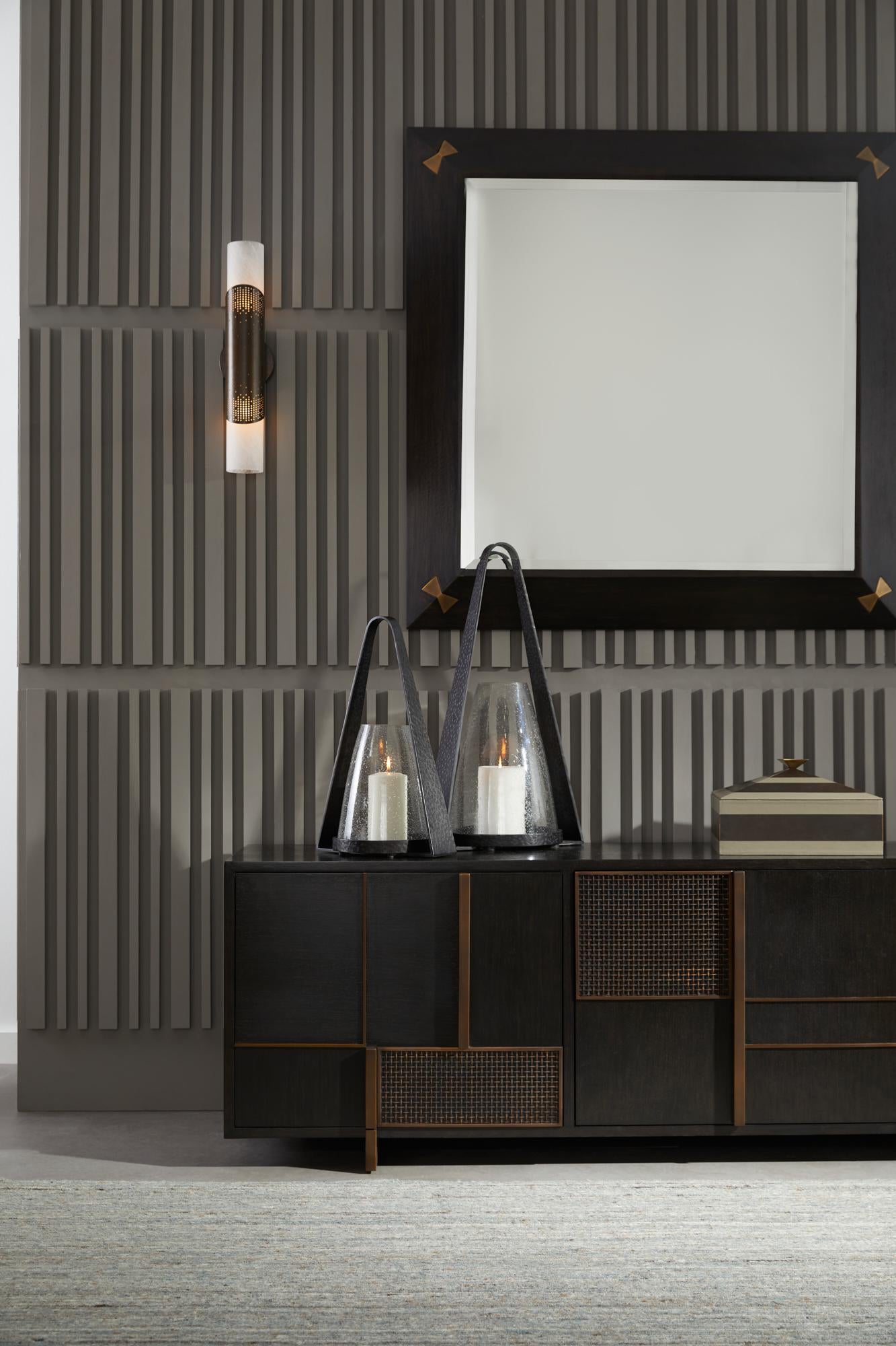 The Calpini Mirror beautifully combines craftsmanship and artistry in a design that captures light and detail from every angle. A polished sable mango wood frame forms the foundation of this elegant piece, while inlaid antique brass butterflies