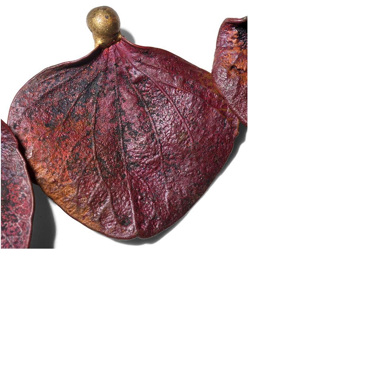 A rare French cast bronze necklace with red-brown patina by Claude Lalanne. The necklace comprises of individual leaves with exquisite detailing, each being a variant from one to another. The coloring, and in some cases the discoloring, almost