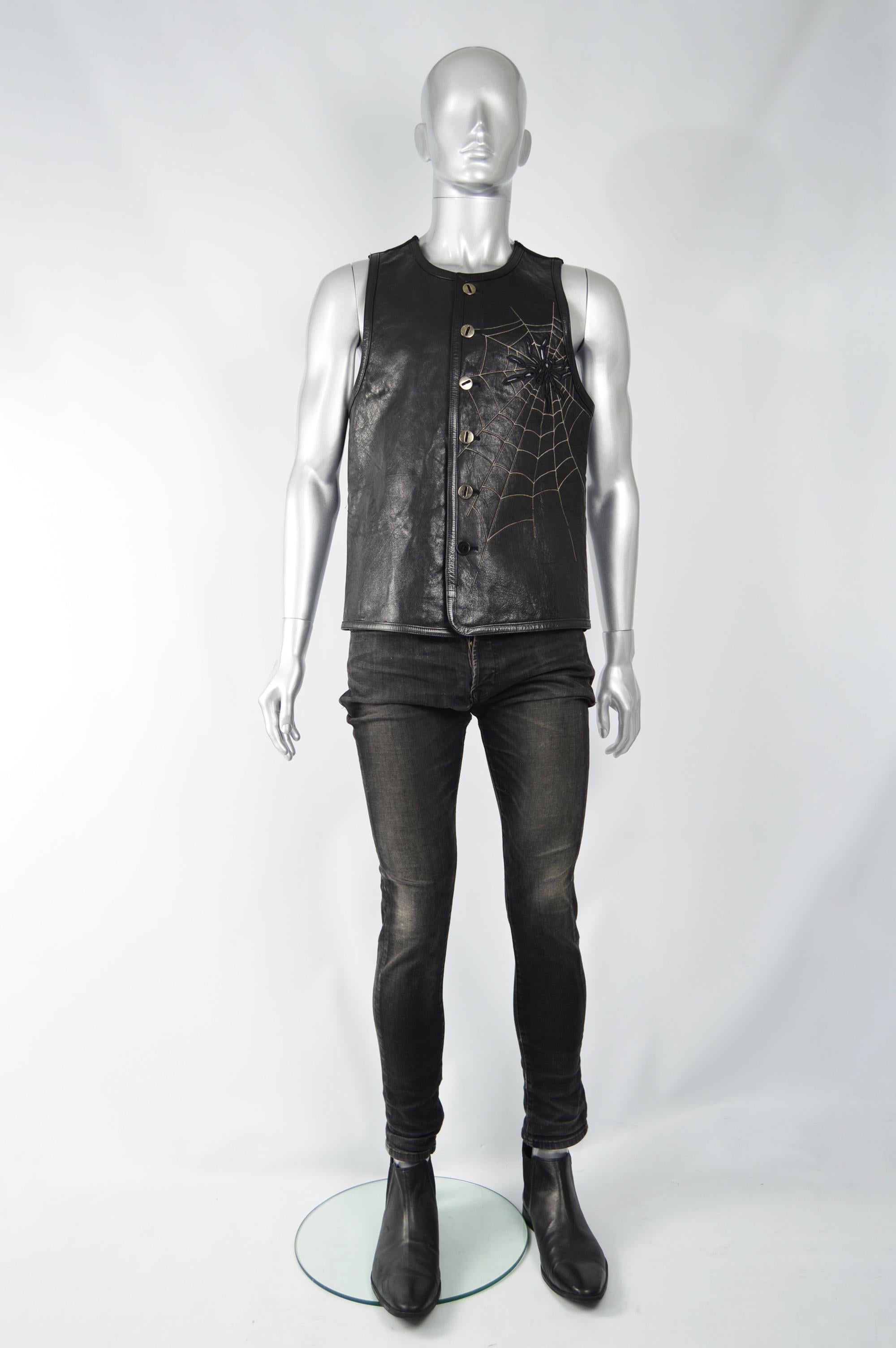An incredible vintage mens leather vest / waistcoat from the 80s by genius Italian fashion designer duo, Calugi e Giannelli. In a black Italian leather with silver lurex embroidery creating a web and an embroidered and cut out spider design. 

Size: