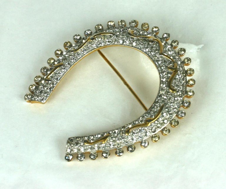 Calvaire Victorian Revival lucky horse shoe brooch. Circa 1940, of gold plated base metal and fine crystal rhrinestone pave.
Excellent Condition, Signed. 
Length 2.50