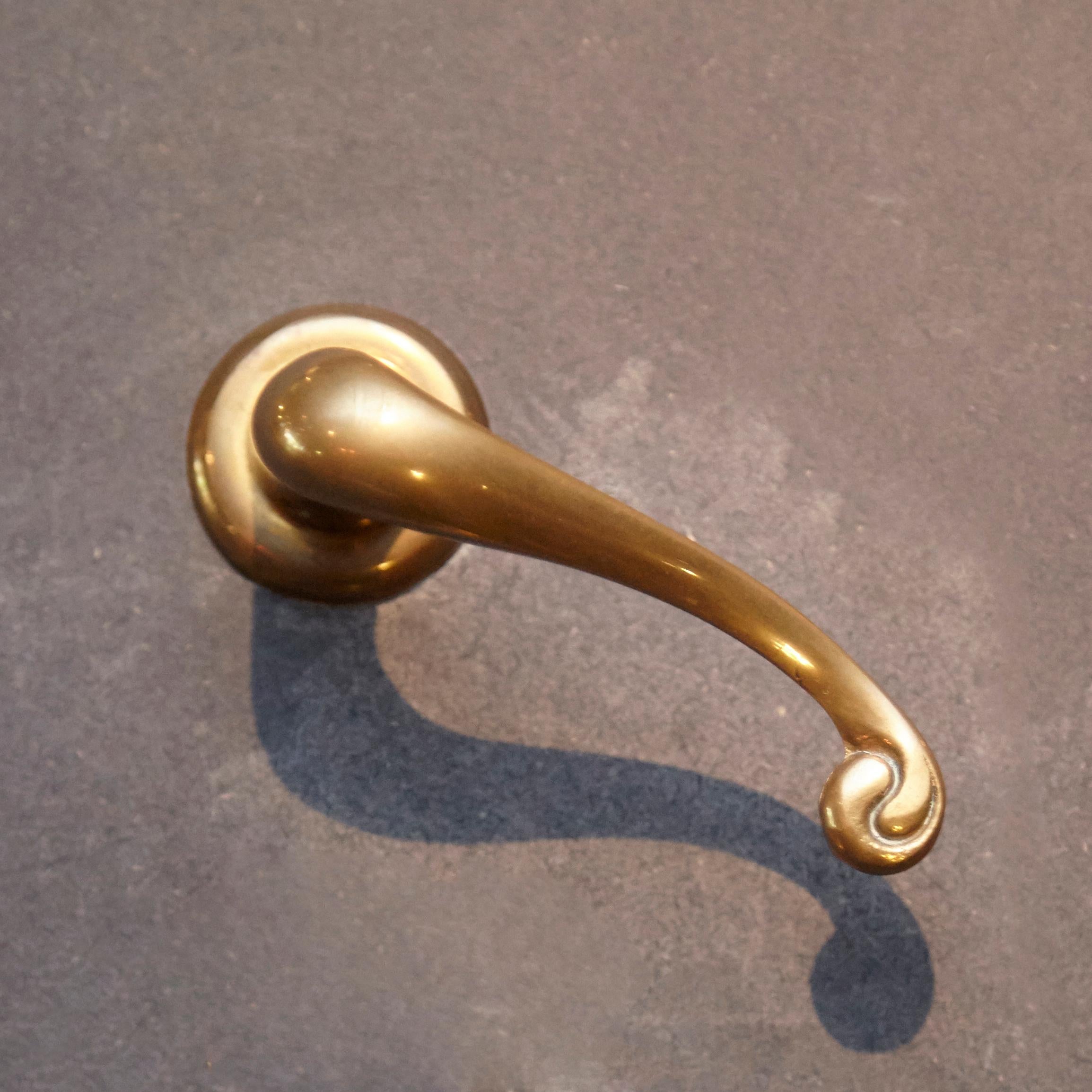 Calvet door handle set by Antoni Gaudí.

Solid cast brass with polished finish.

An exact reproduction in both form and material original metalwork fittings designed by Antoni Gaudí for various of his works of architecture. This unique series