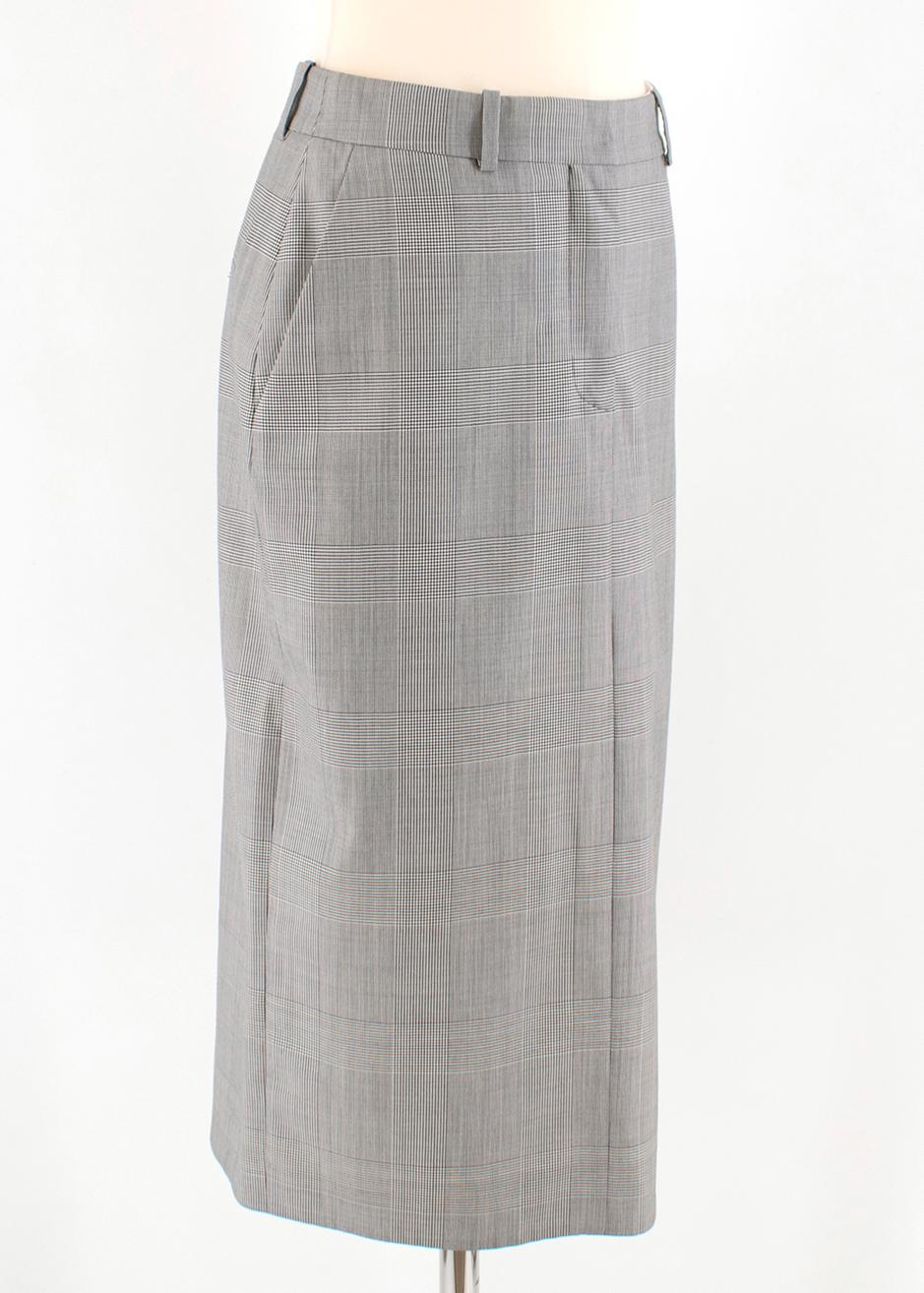 Calvin Klein 205W39NYC Prince of Wales Checked Pencil Skirt

- Grey, lightweight Prince of Wales checked wool
- High rise, midi length 
- One pocket on the hip
- Hemline vent
- Zip closure

Please note, these items are pre-owned and may show some