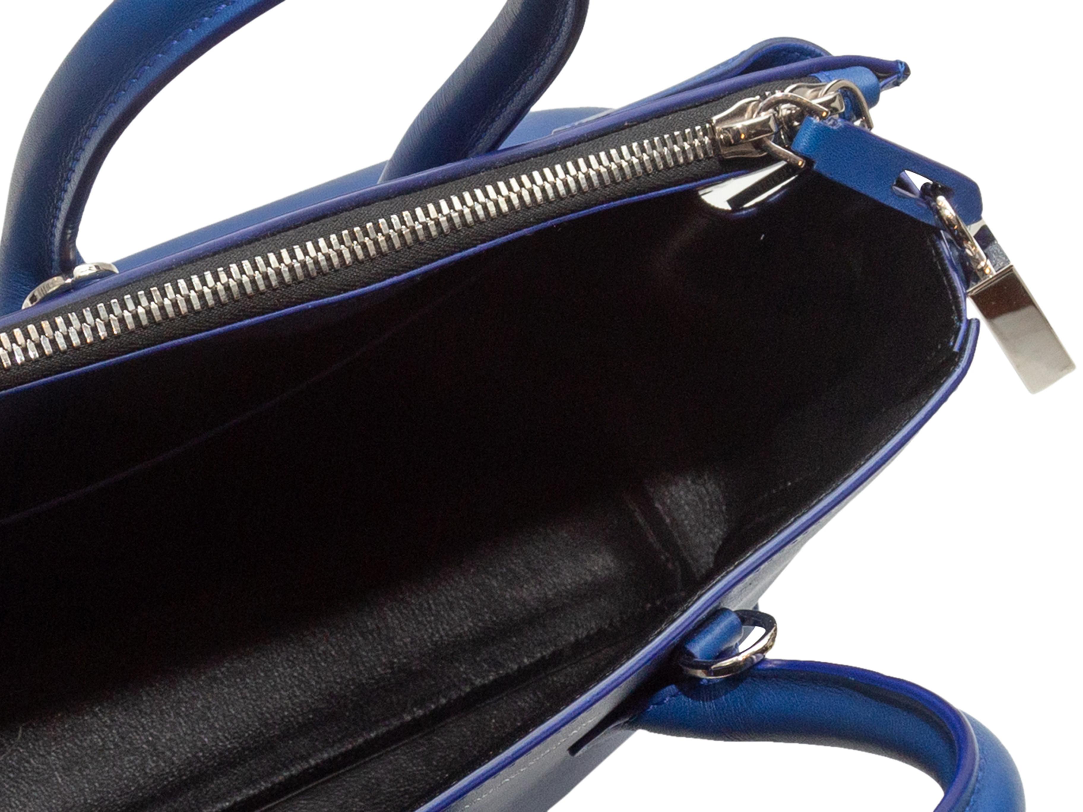 Product Details: Blue Calvin Klein 205W39NYC Leather Handbag. This bag features a leather body, silver-tone hardware, dual rolled top handles, optional flat shoulder strap, and a zip closure at the top. 10