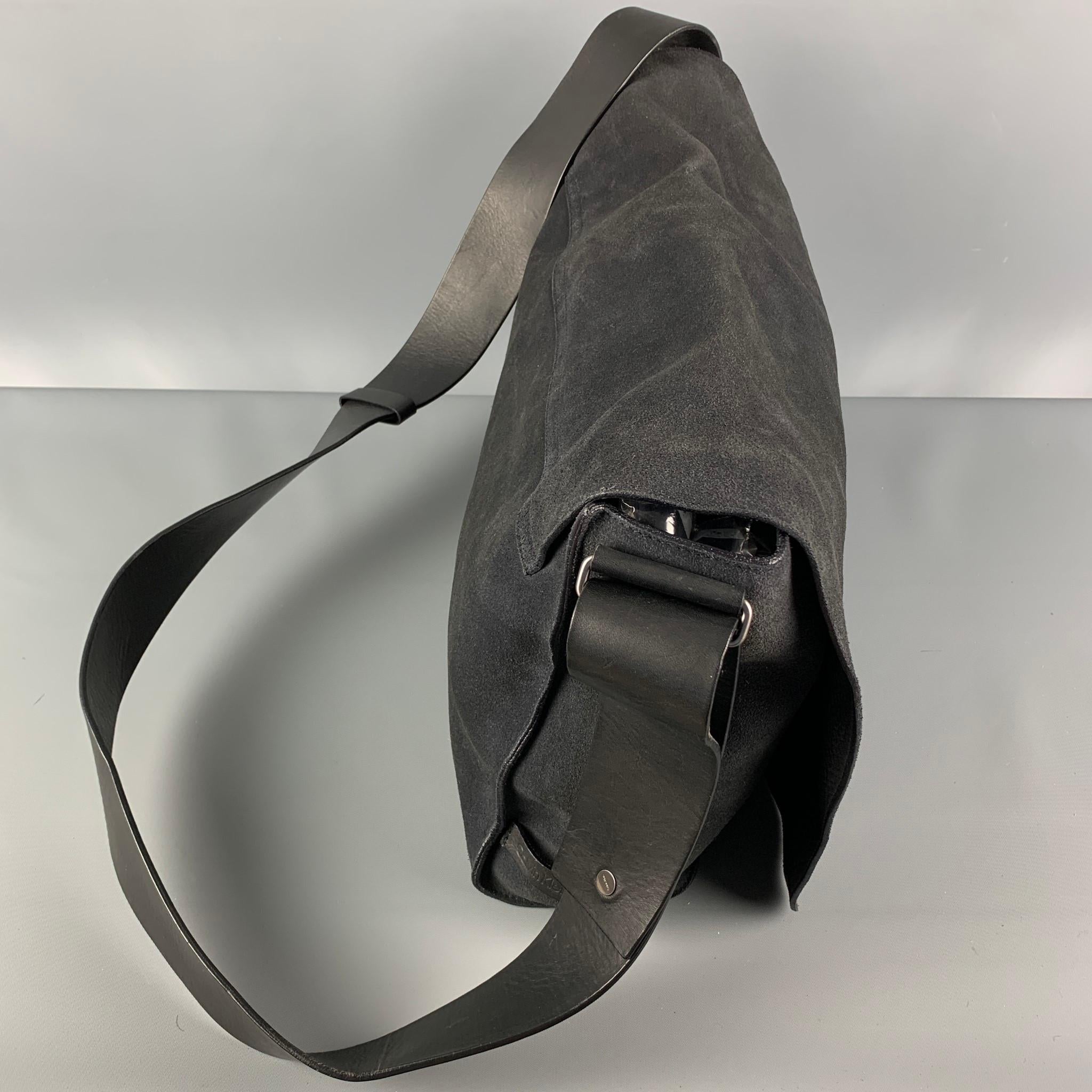 CALVIN KLEIN bag comes in a charcoal suede featuring a messenger style, leather crossbody strap, inner pockets, and a front flap design. 

Good Pre-Owned Condition.

Measurements:

Length: 17.5 in.
Width: 4 in.
Height: 10.5 in.
Drop: 23 in. 