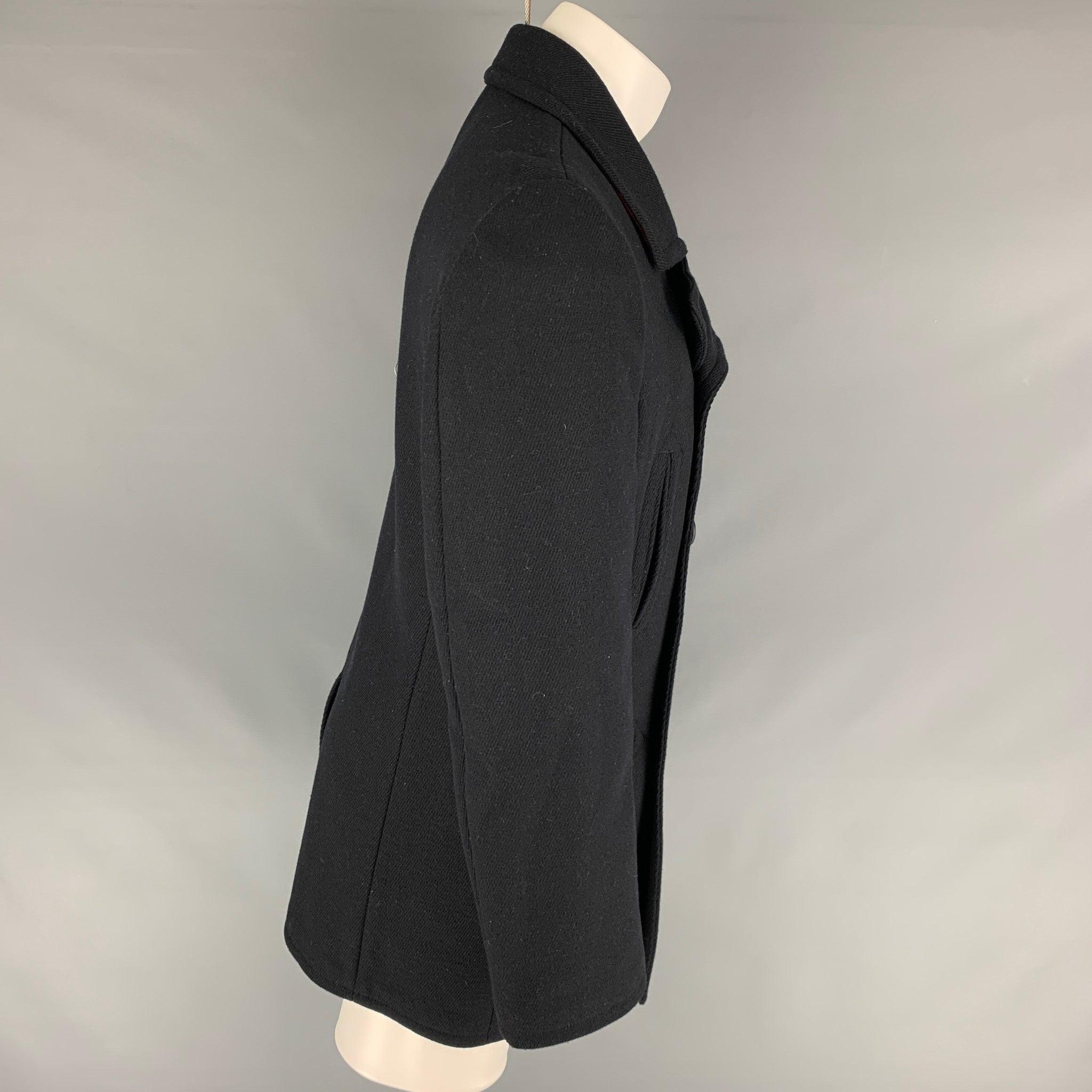 CALVIN KLEIN pea coat comes in a navy blue wool, featuring a notch lapel, and welt side pockets.Excellent Pre-Owned Condition. 

Marked:  40 

Measurements: 
 
Shoulder: 18 inches Chest: 40 inches Sleeve: 26 inches Length: 35 inches 


 
 
